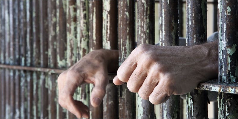 pioneers in prison bars hands Why Are These Pioneers Still Rotting In Prison Now That Marijuanas Mainstream?