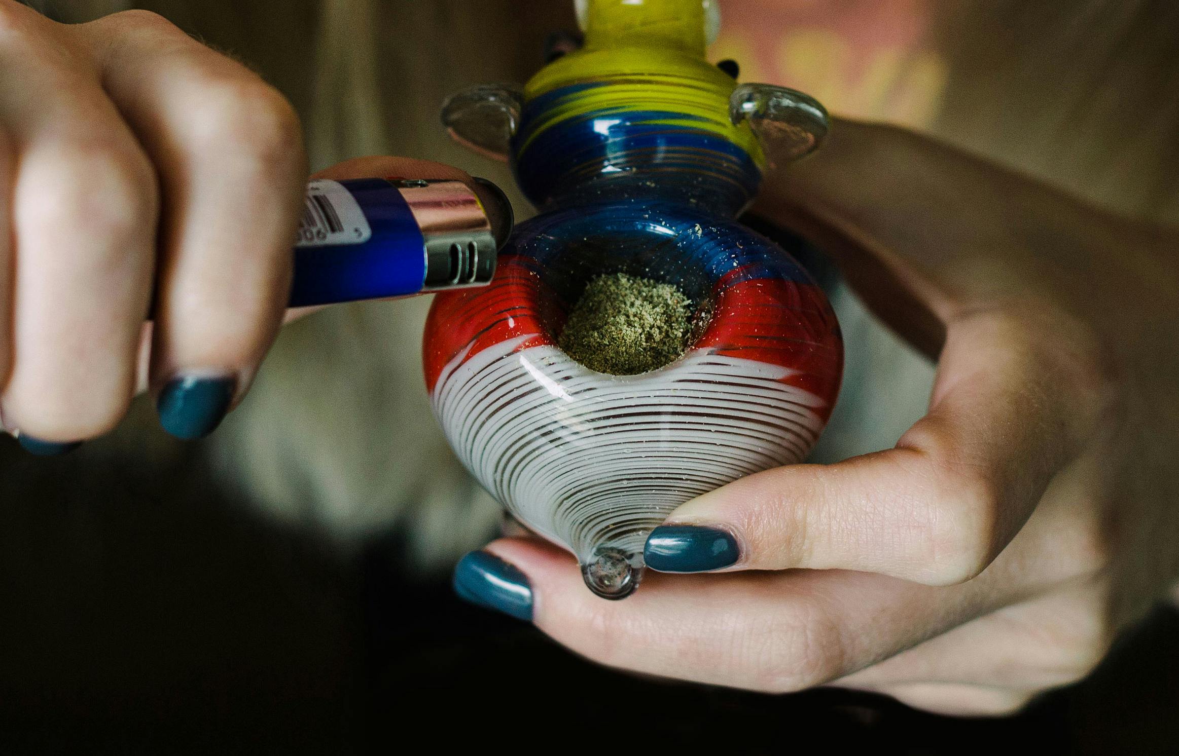 Woman smoking weed with an elephant pipe