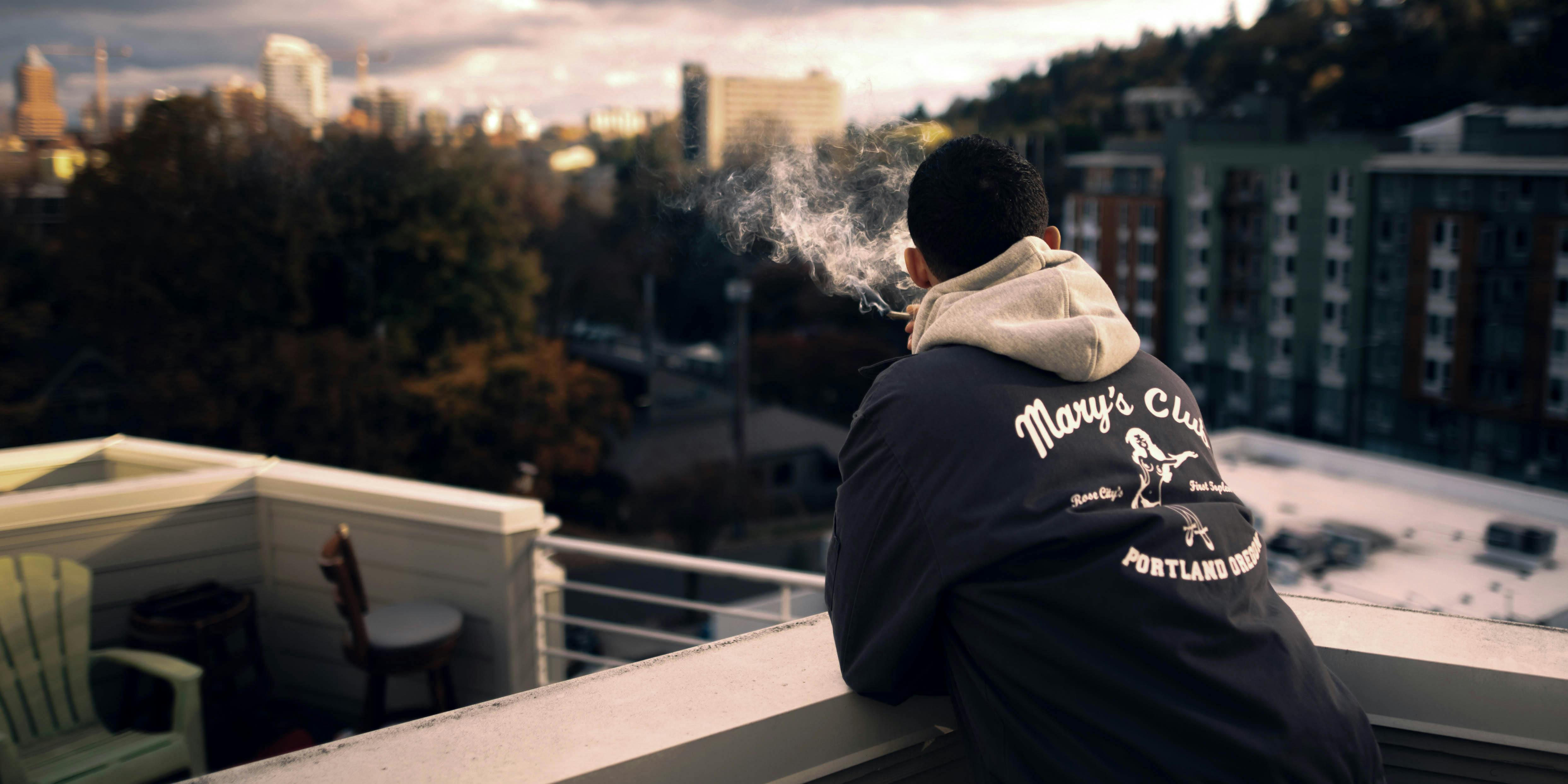 Someone smokes on a rooftop. Can CBD help with depression?