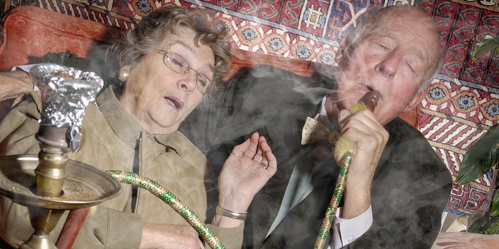 Senior couple smoking hookah pipe to smoke weed