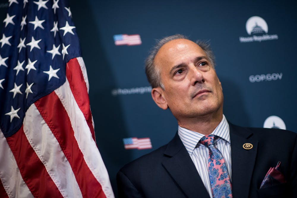 Rep. Tom Marino stands in front of an american flag, recently he just withdrew after a damning opioid report