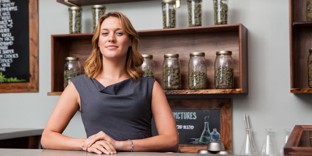 a female owner of a marijuana dispensary in Portland Oregon poses with cannabis product