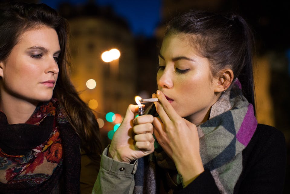 Young women smoking marijuana together