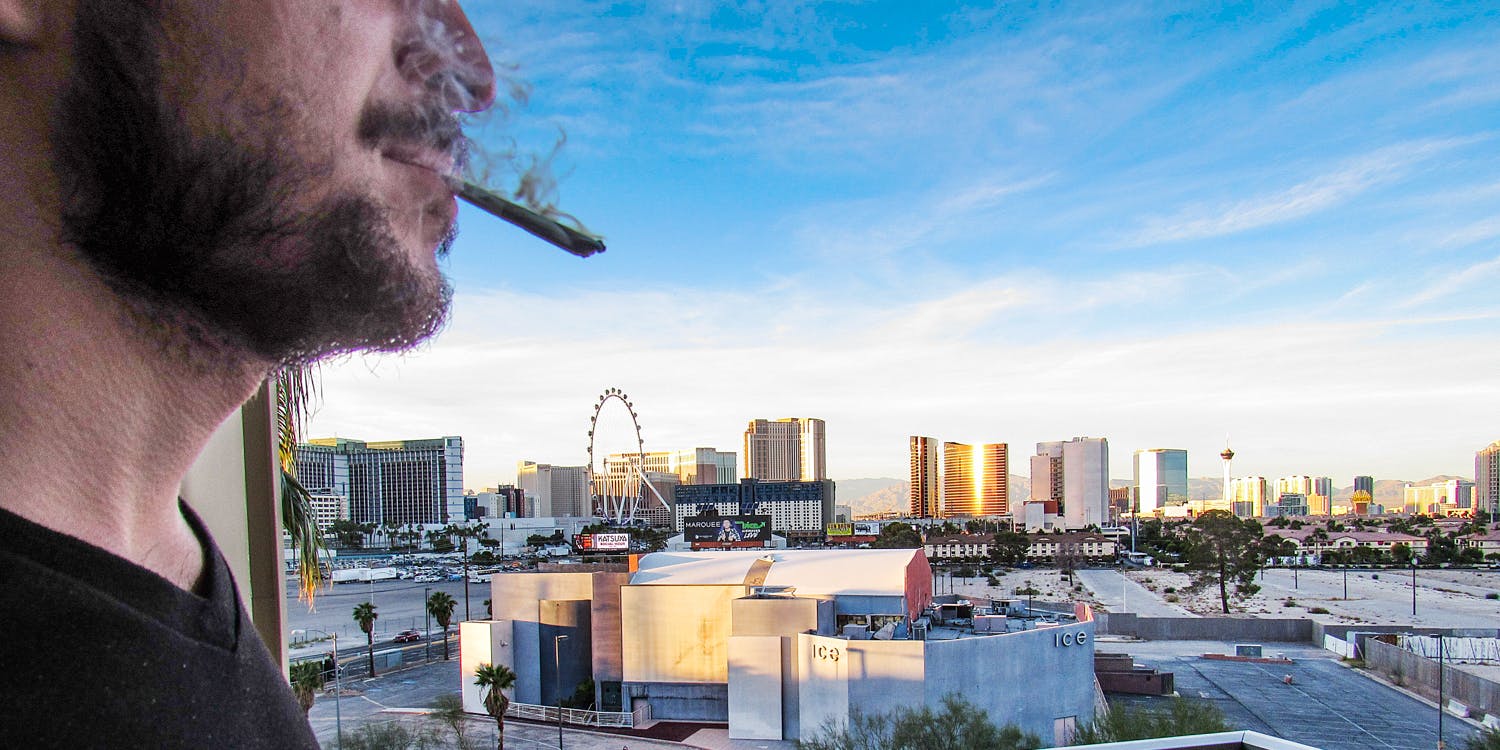 man smoking joint infant of Nevada casino
