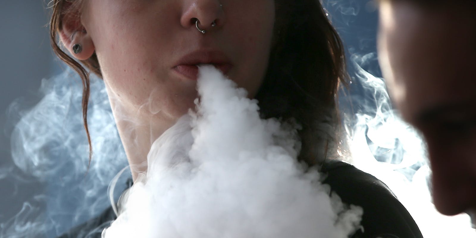 Grl with Aritzer vape blowing smoke