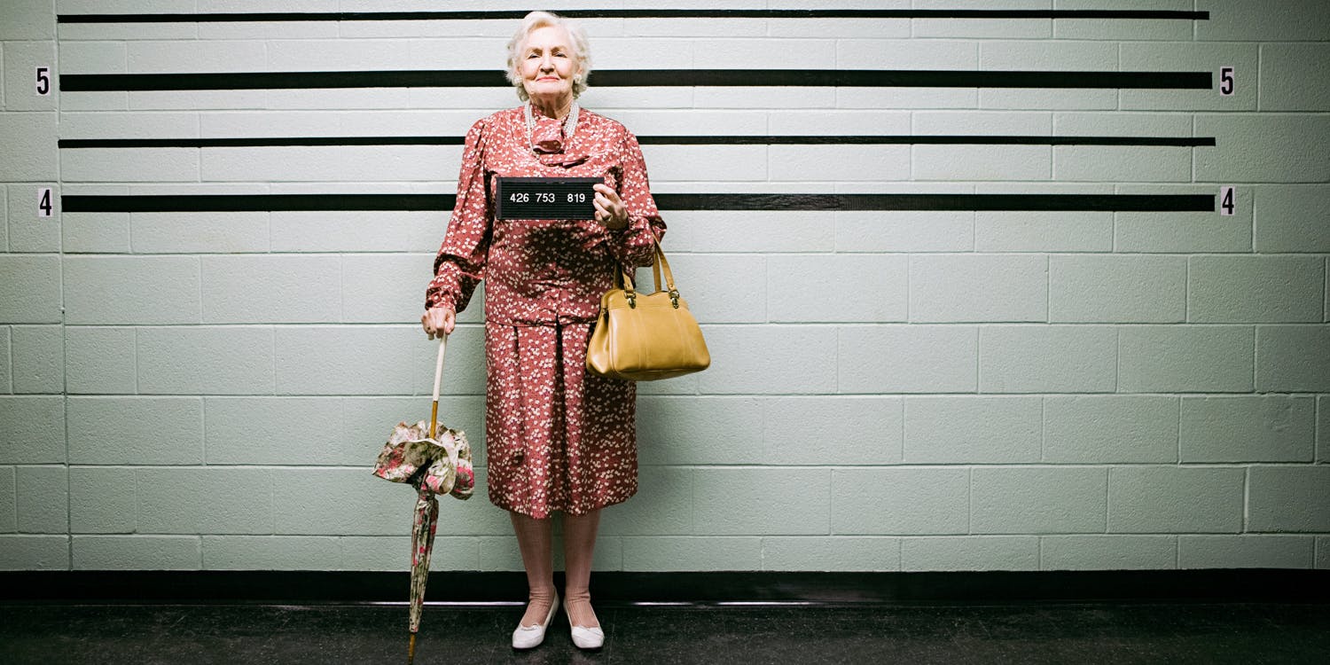 cute old woman getting mugshot taken