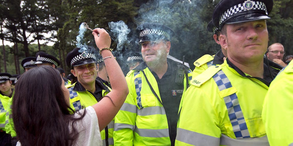 Woman puts incense in front of UK police face