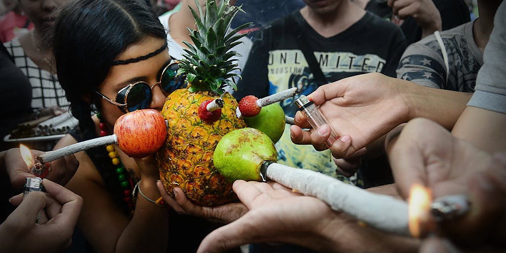 Woman smoking cannabis through various fruits and joints