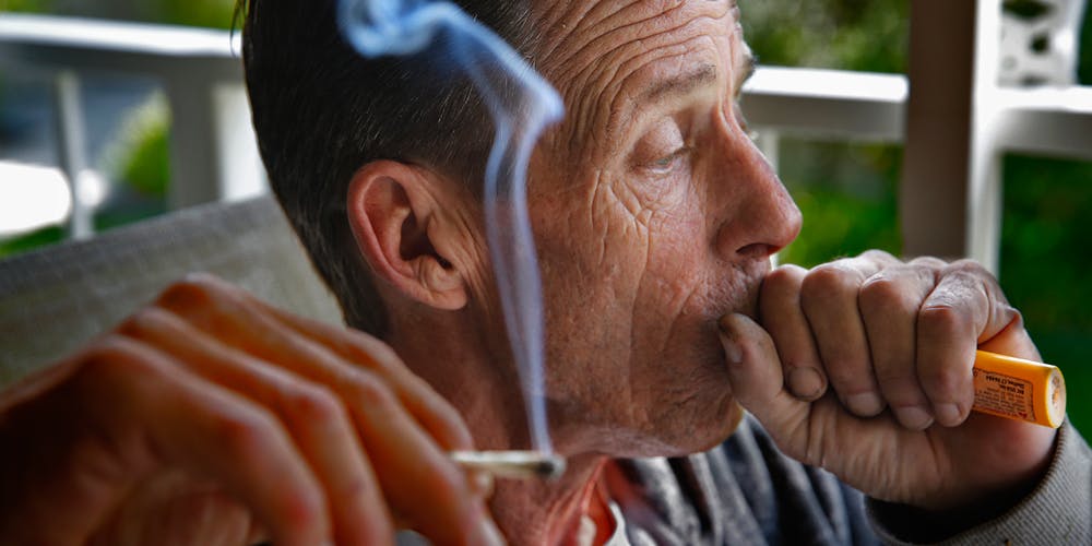 On the porch of his Laguna Woods home, Robert Evans, 52