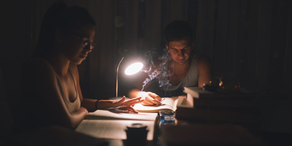 Two college students studying while smoking and studying