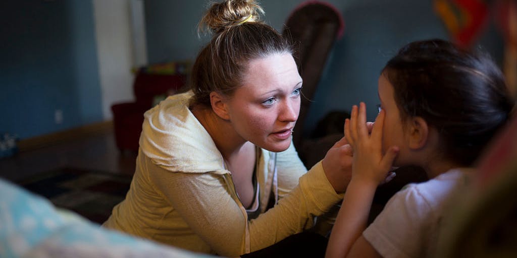 Woman comforting her crying daughter