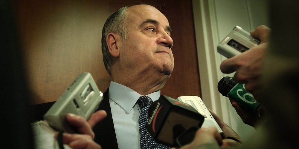 Julian Fantino with a lot of mics held up to his face