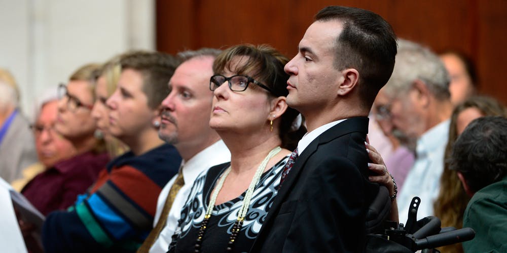 Brandon Coats, right, waits for the proceedings to begin with his mother Donna Scharfenberg sitting by his side.