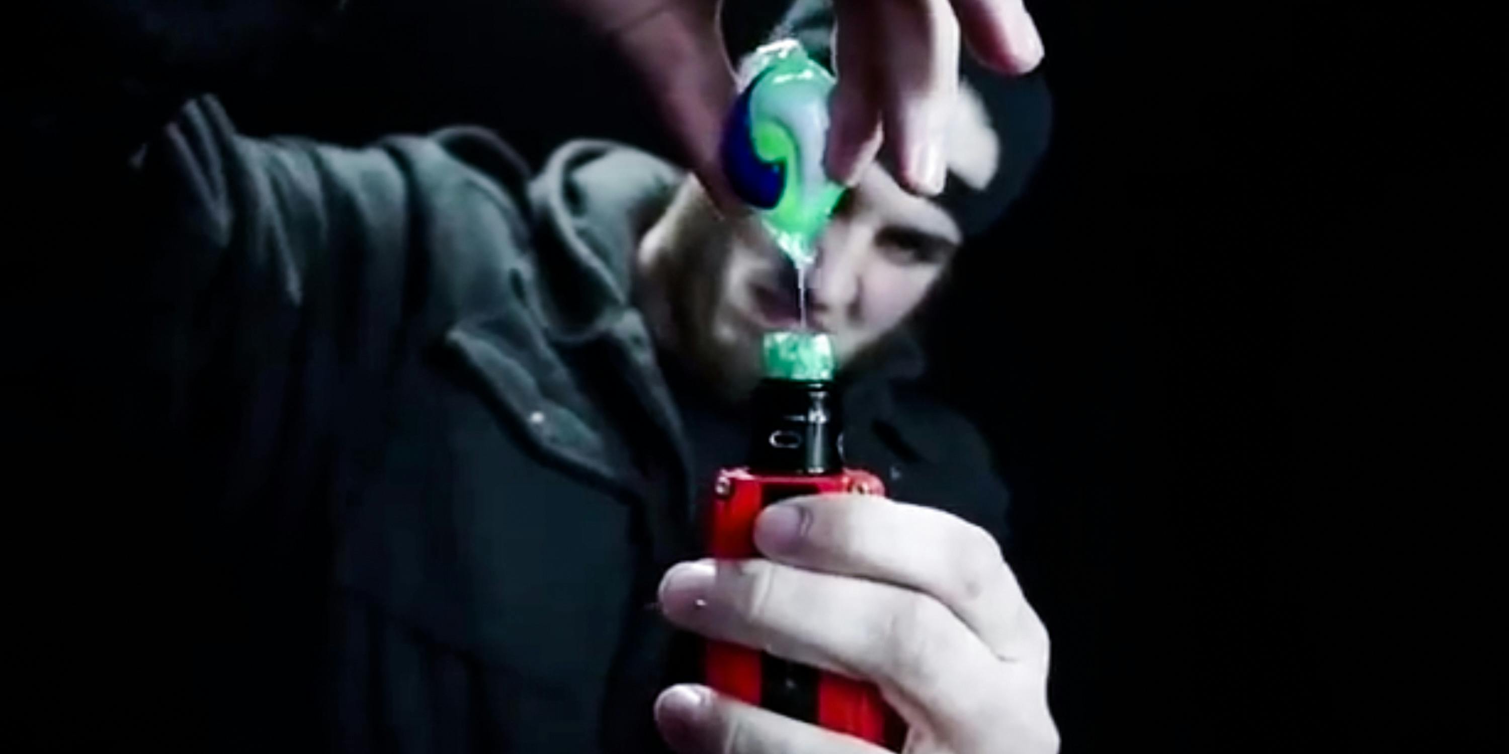 Man Pouring tide pod gel into a vape