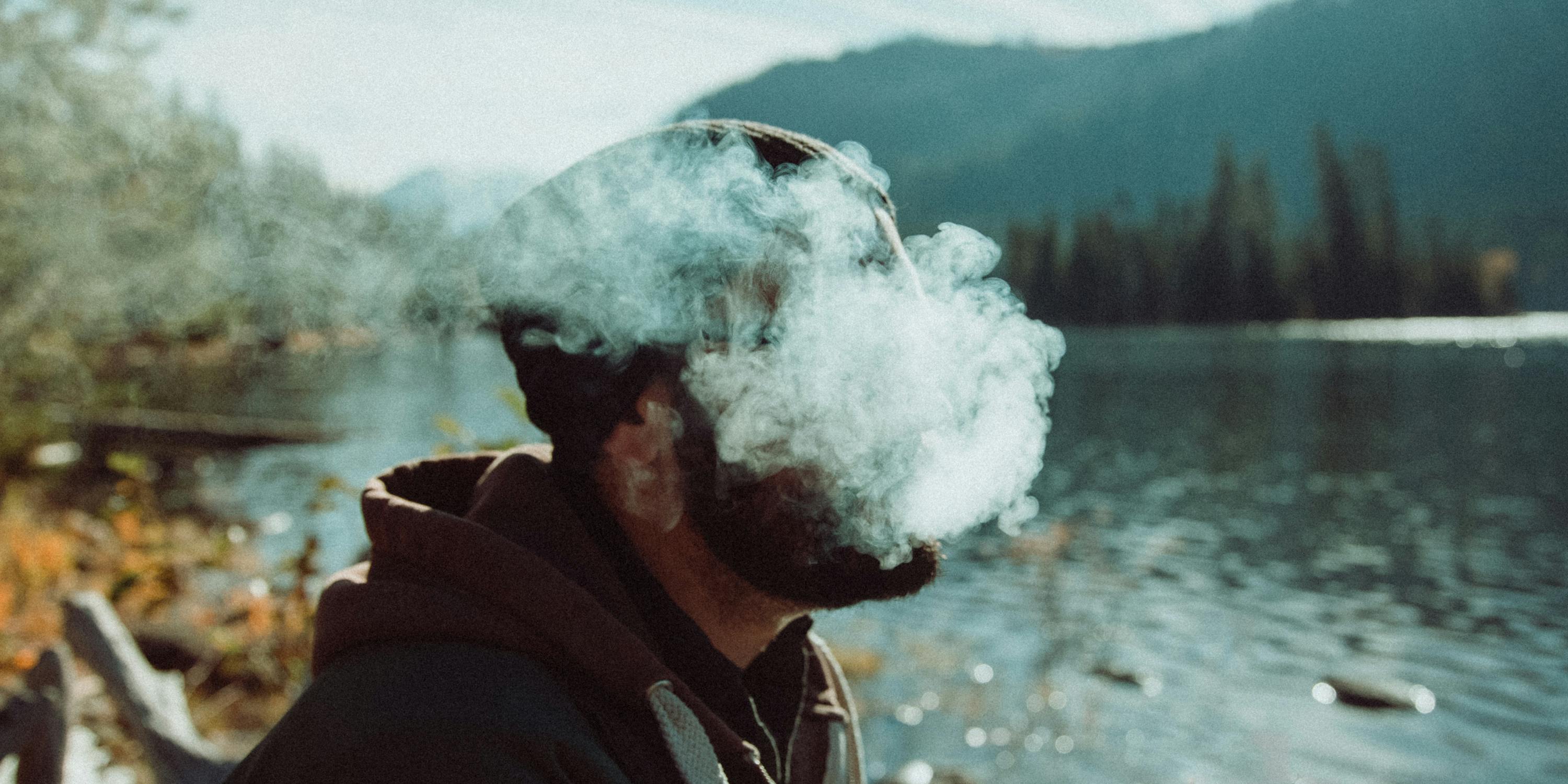 Man smoking cannabis with the polar blast on an ice cold mountain