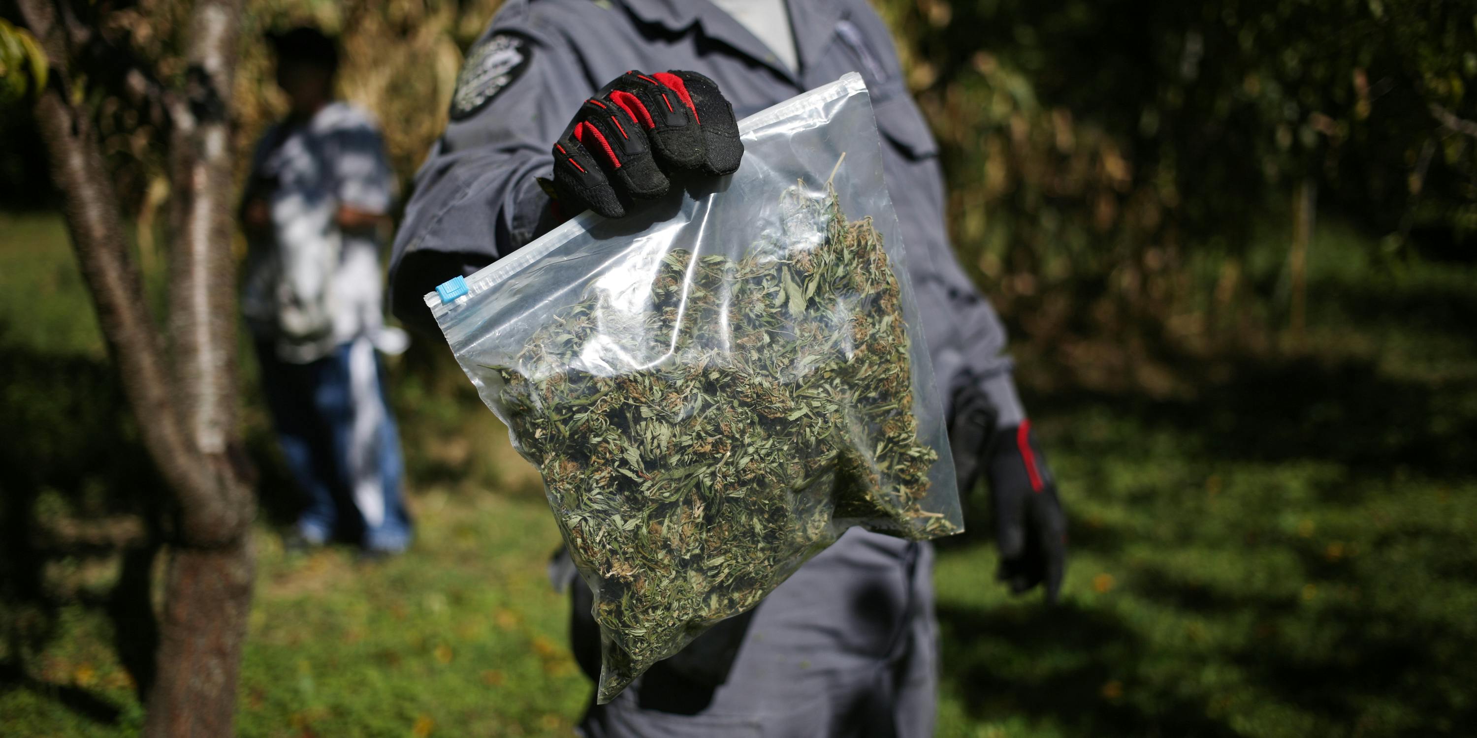 police officer with a bag of marijuana