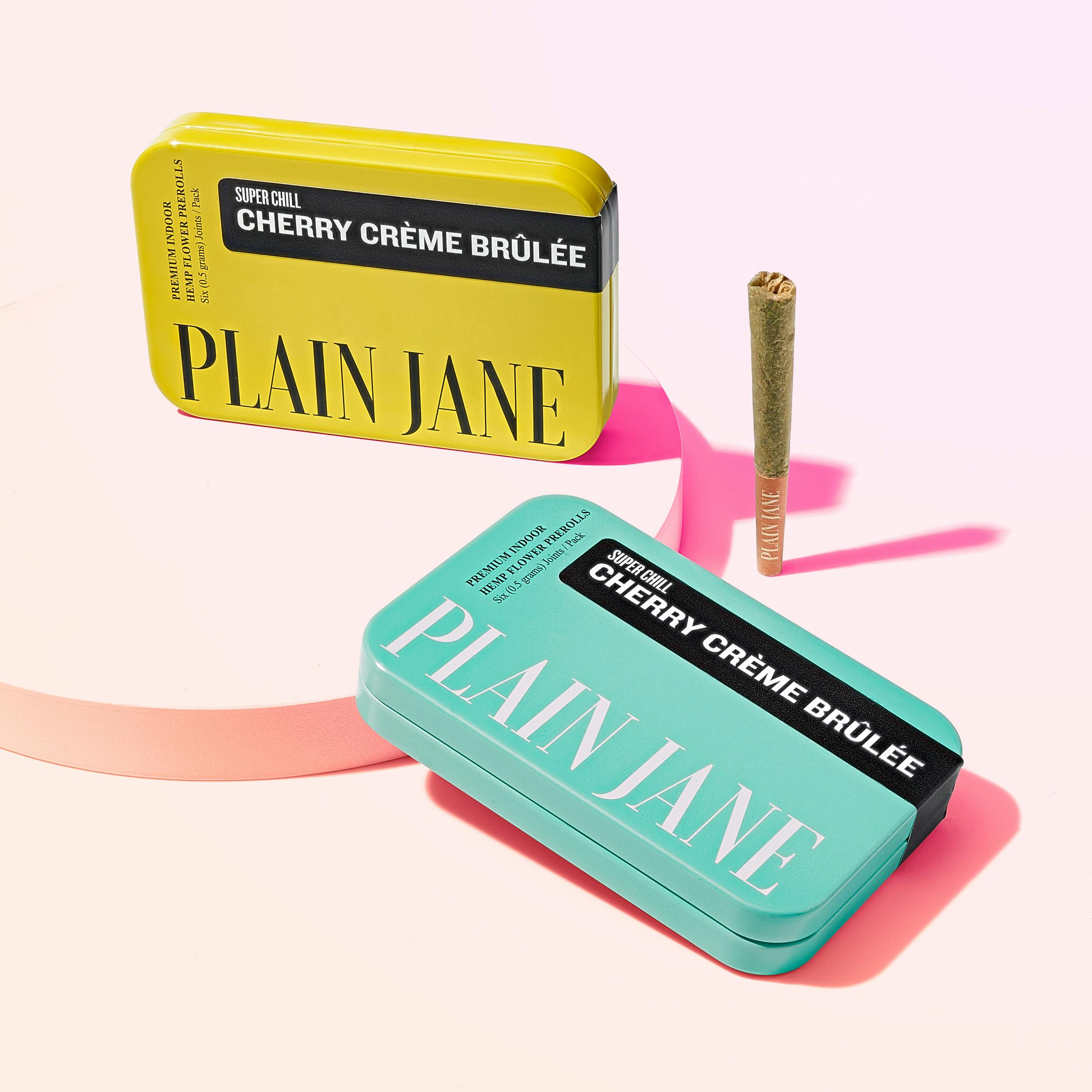 Plain Jane Cherry Creme Brulee 6 Pack Joints turquoise yellow tins group shot on white background with one joint on the outside  Flying With Weed: How To Get Weed Through Airport Security