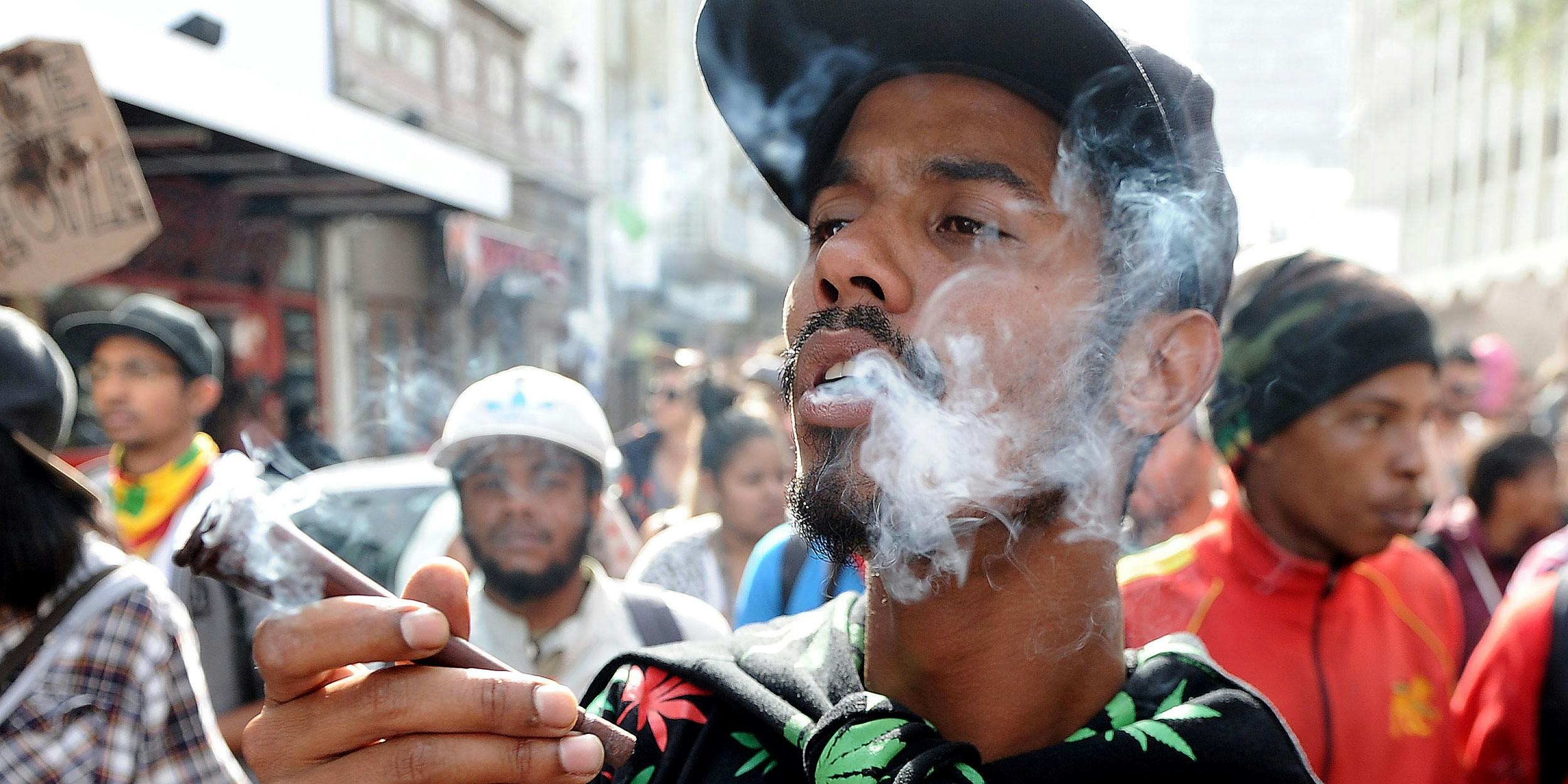 a man smokes marijuana during a marijuana march. Africa’s first medical marijuana dispensary is about to open in South Africa.