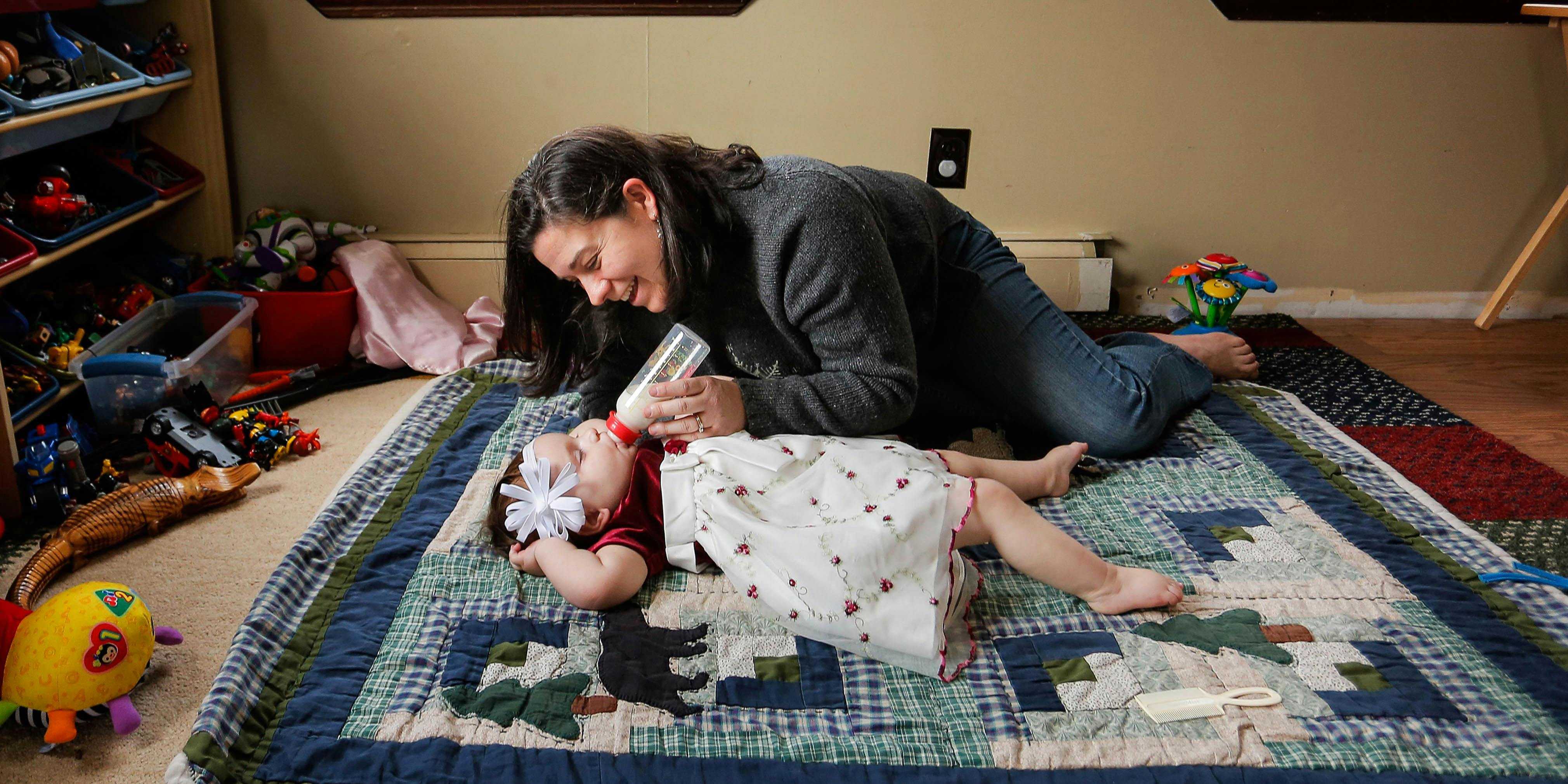 Meagan Patrick plays with her daughter, Addie, at their Acton home Wednesday, Dec. 4, 2013. Addie suffers from severe epilepsy, and research shows that medical marijuana can help cut down on the number of seizures the children have. Patrick is so desperate to try it for Addie, she is flying to Colorado later this month - a state that is at the forefront of research for pediatric uses of medicinal marijuana - to establish legal residency there. (Photo by Gabe Souza/Portland Press Herald via Getty Images)