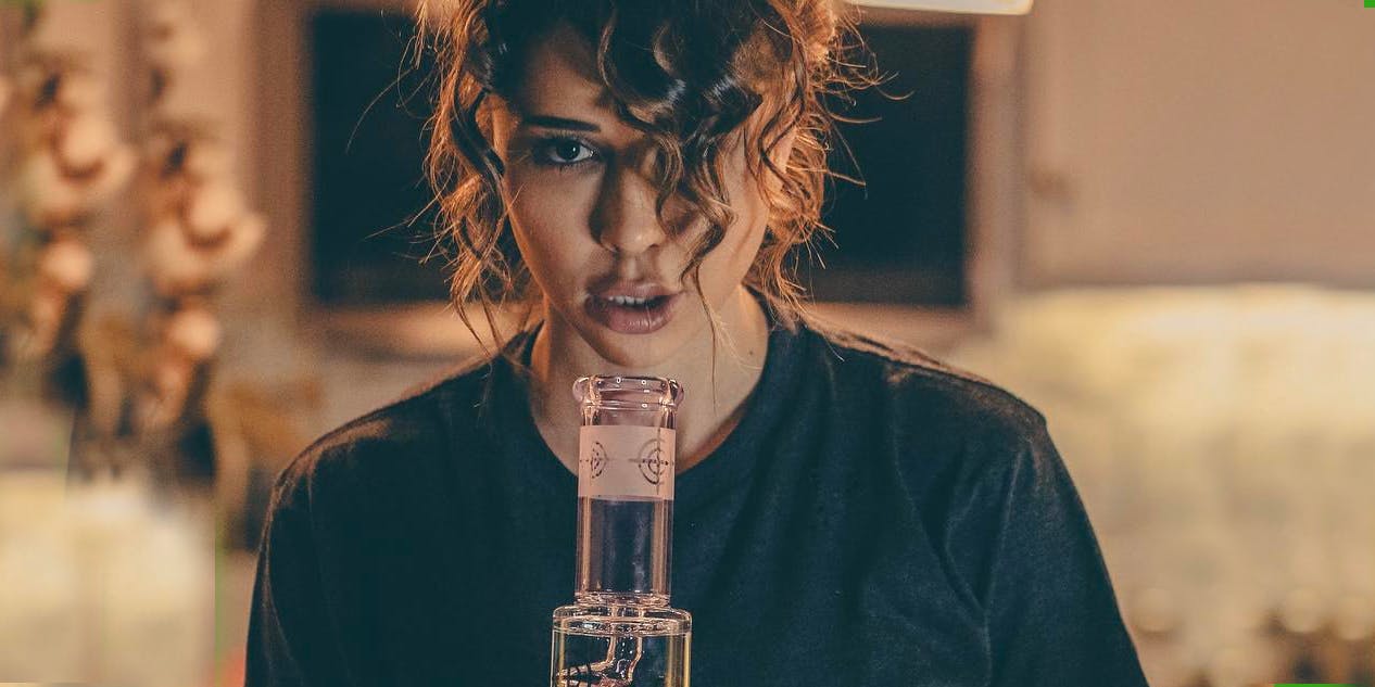 Close up of woman smoking from beaker bongs