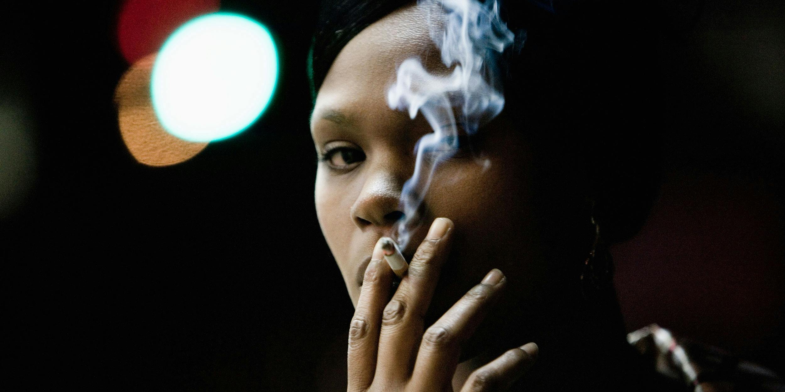 Woman smoking a cigarette. Imperial Brands is investing in the cannabis industry