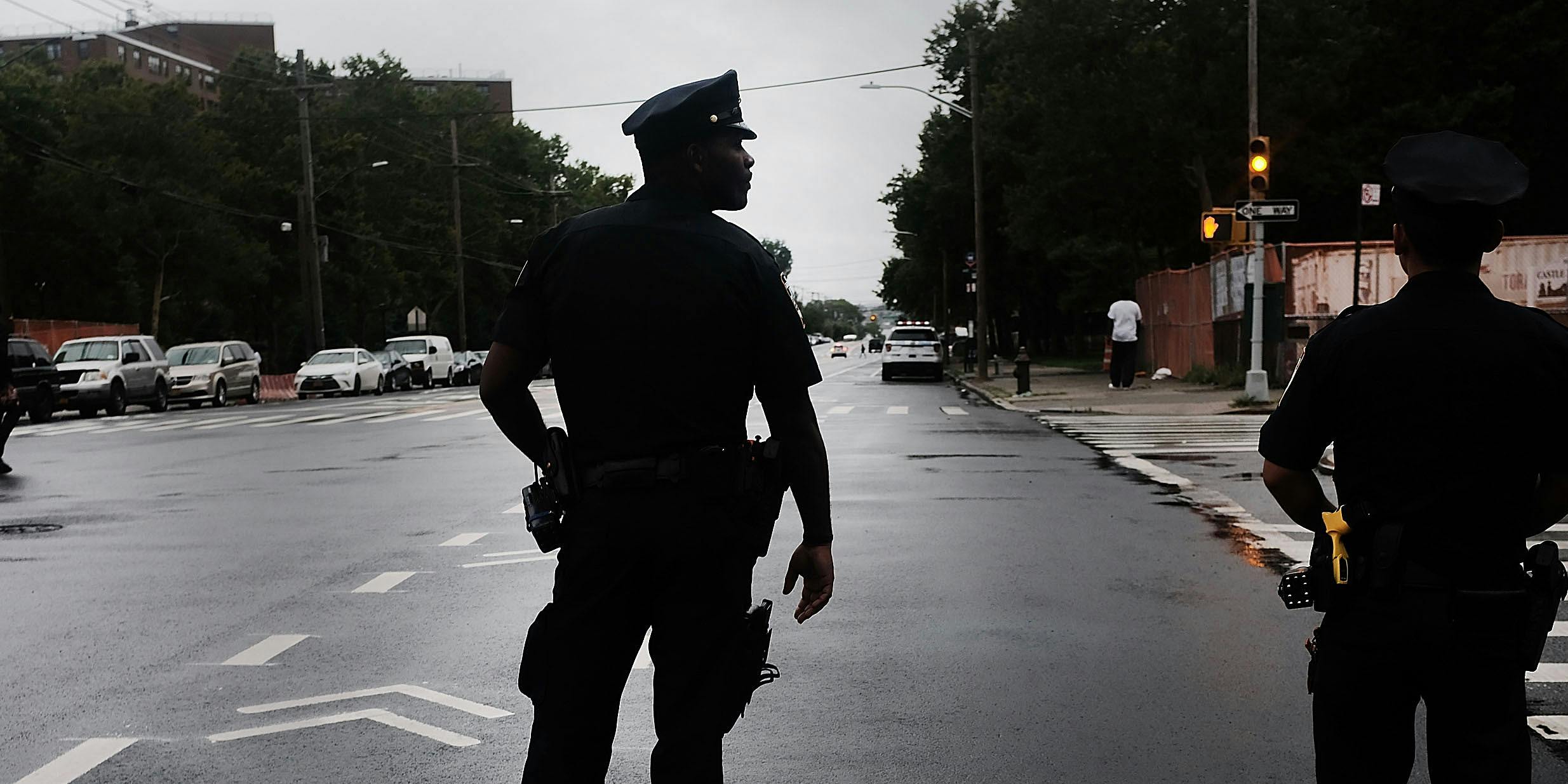 A police officer stands on patrol as people participate in a Silent Peace March against Violence in the Bronx on July 25, 2018 in New York City. A recent study found cannabis legalization does not lead to an increase in felonies in Washington