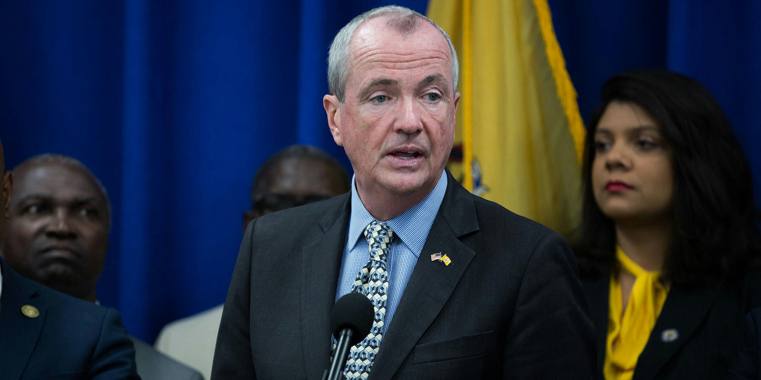 Phil Murphy, governor of New Jersey, speaks while Ras Baraka, mayor of Newark, left, listens during a budget press conference in Newark, New Jersey, U.S.