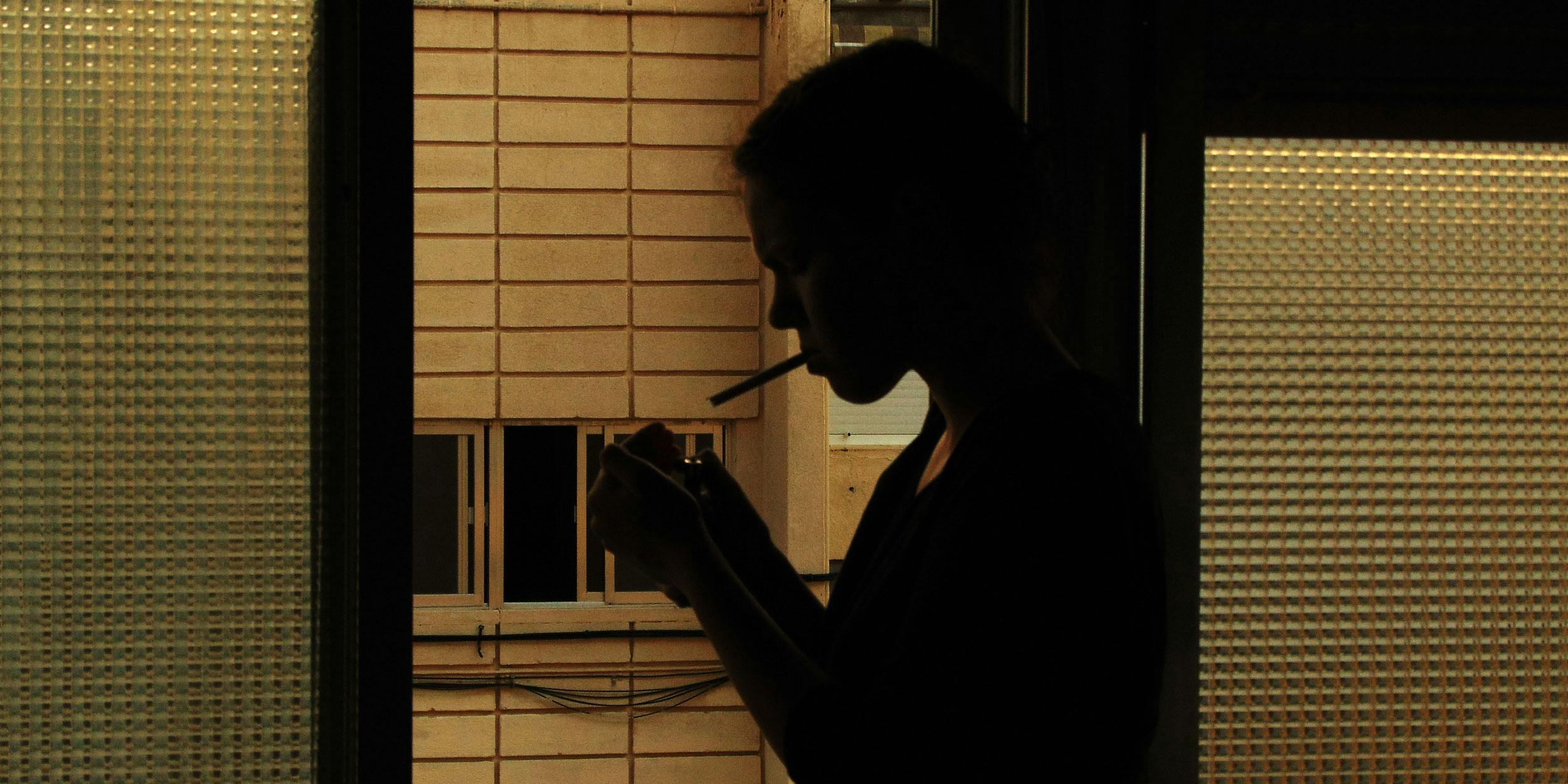 Woman sues sodexo for firing her for recreational cannabis use. Here, a woman is seen smoking at night