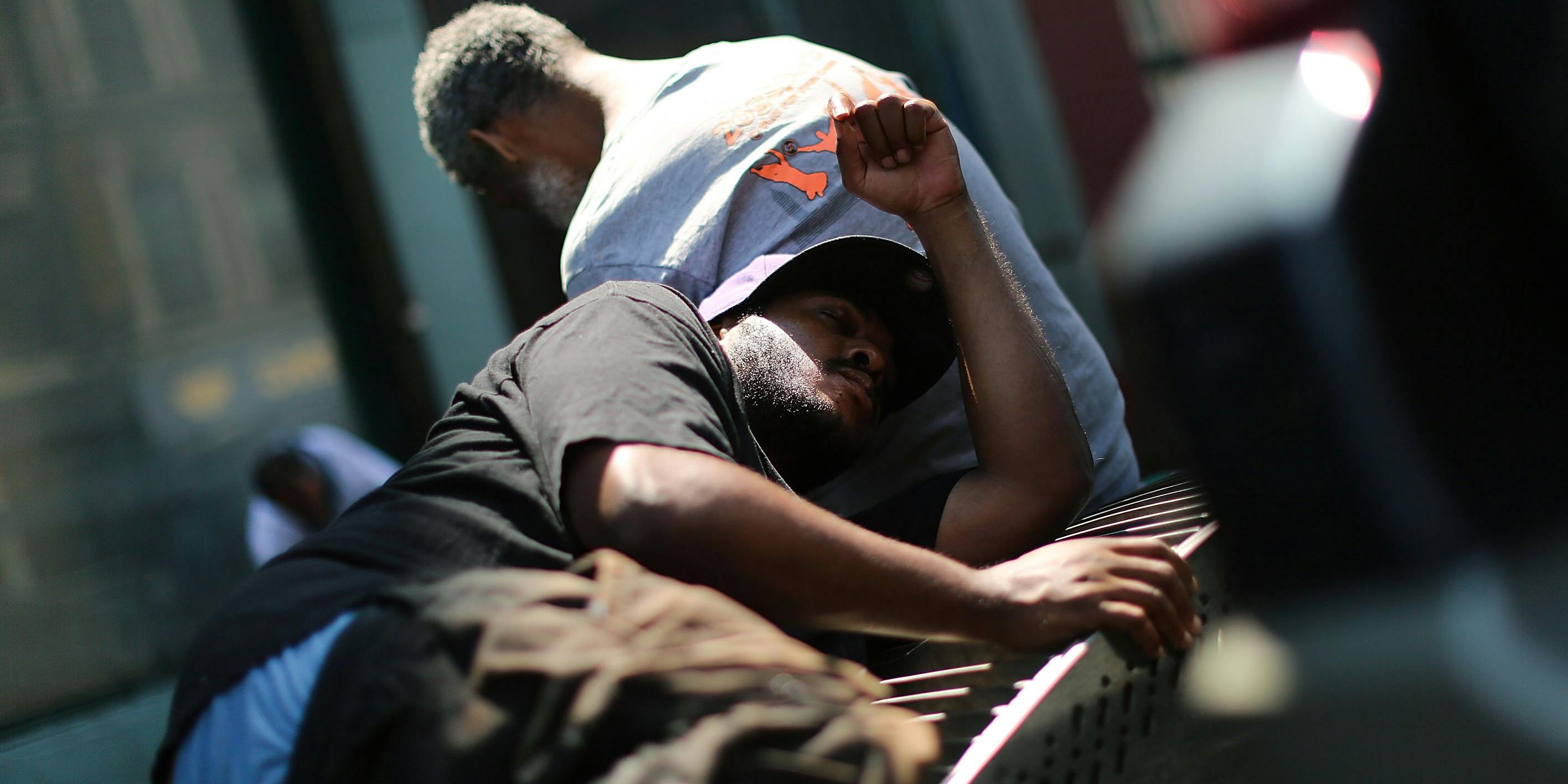 NEW YORK, NY - AUGUST 05: Men who are high on K2 or “Spice,” a synthetic cannabis drug, sleep along a street in East Harlem on August 5, 2015 in New York City. (Photo by Spencer Platt/Getty Images)