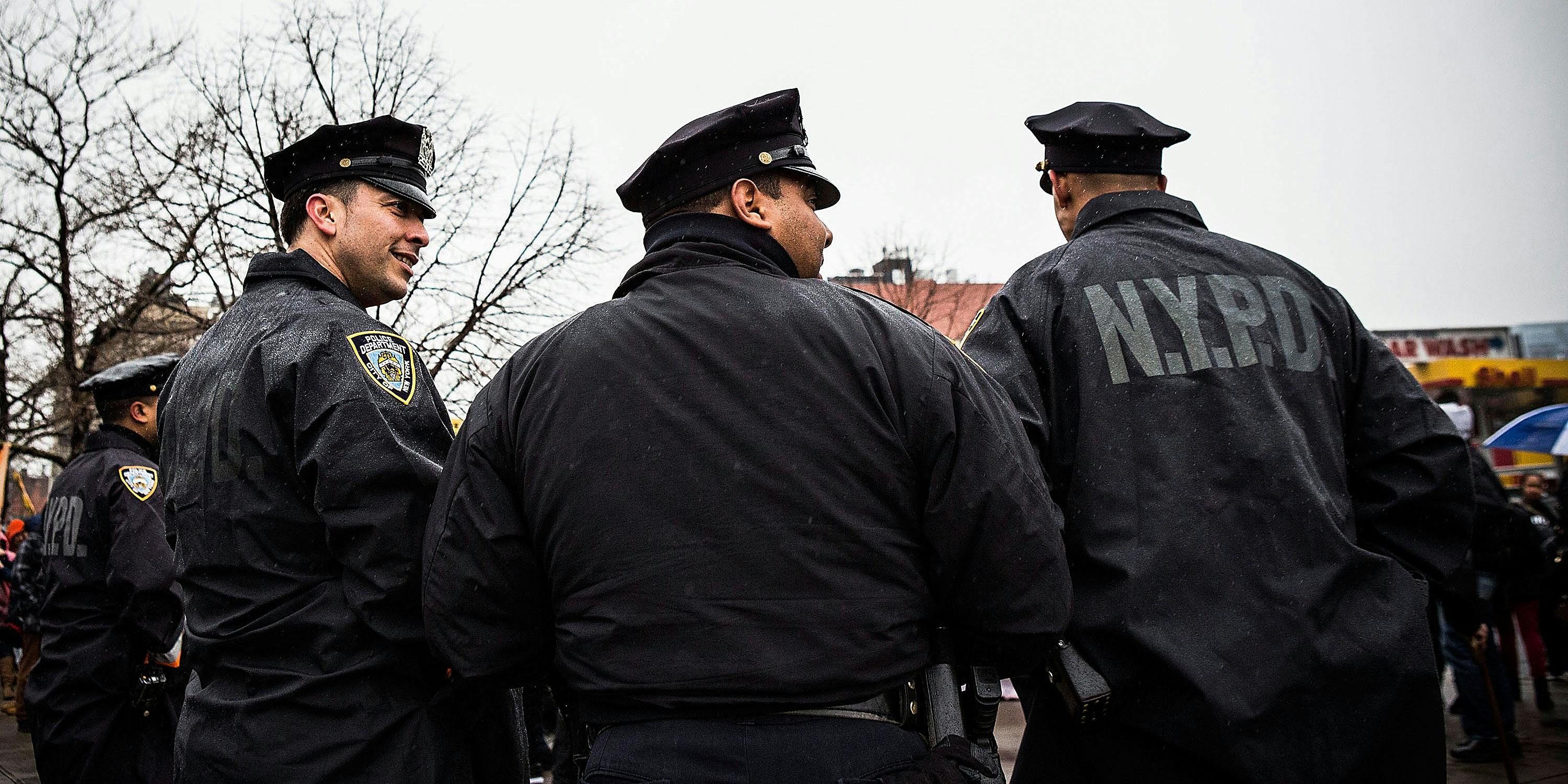 NYPD officers monitor a march against stop-and-frisk tactics used by police on February 23, 2013 in New York City. The march, which consisted of a few hundred people, started in the Bronx borough of New York and marched into the Harlem neighborhood of Manhattan. (Photo by Andrew Burton/Getty Images)