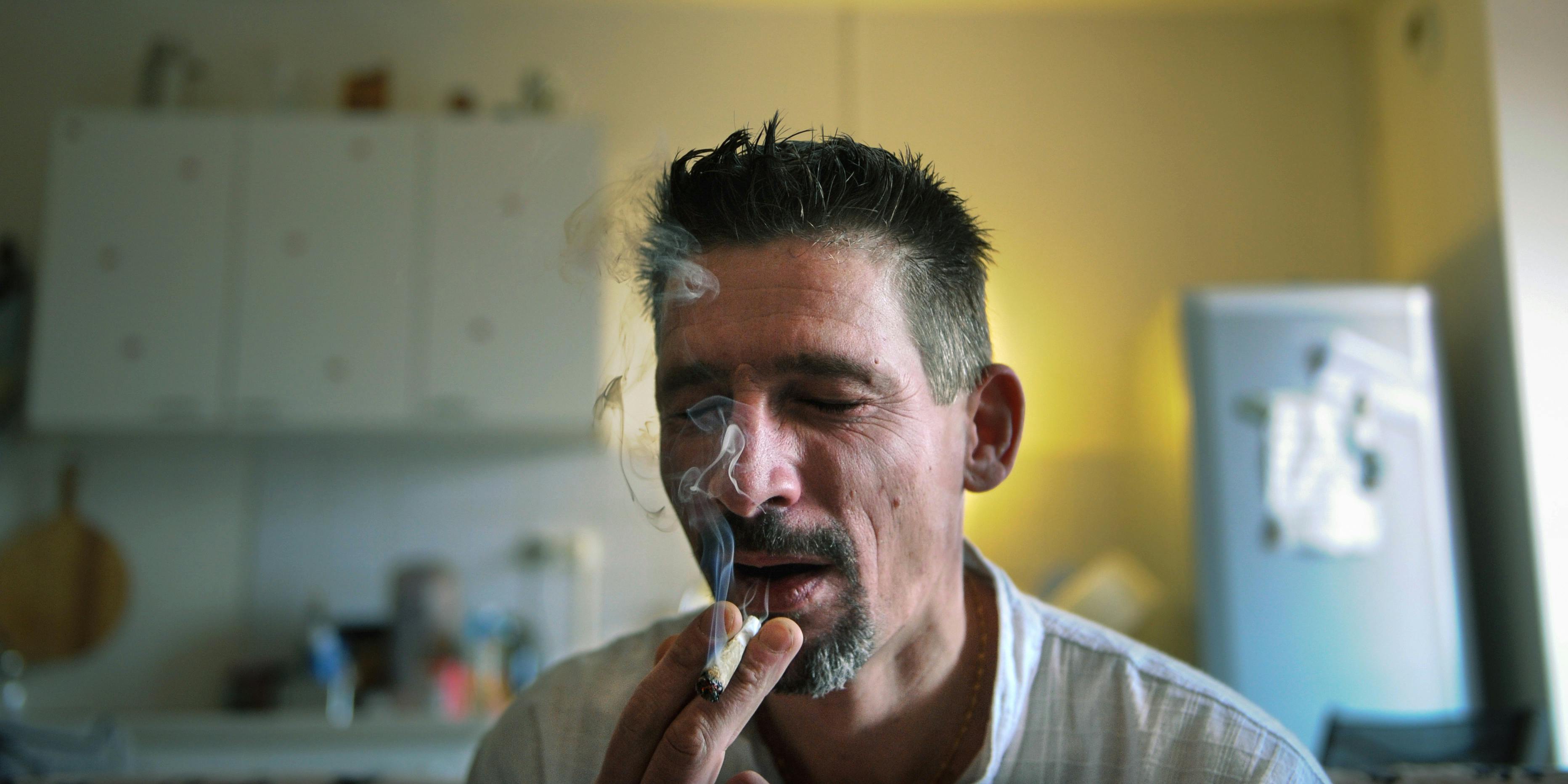 Dominique Loumachi, suffering from Dermatomyositis (Myopathy), smokes a cigarette that looks like a cannabis cigarette - in order not to be charged for promoting consumption of narcotic substances - while posing on February 28, 2013 in Belfort, Eastern France. Some medical marijuana patients prefer cannabis in smokeable form, but that hasn't prevented some states, like Oklahoma, from banning it.