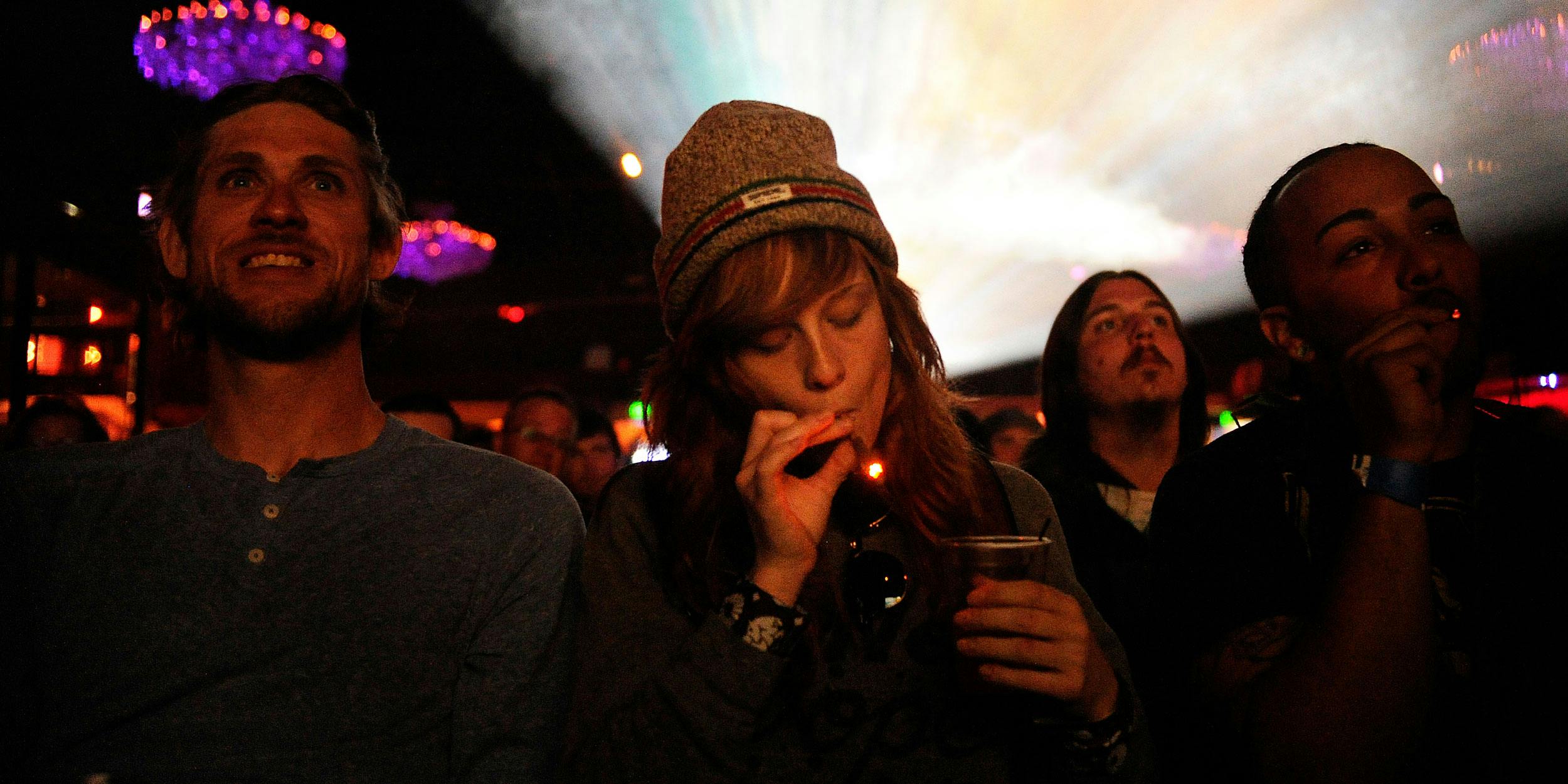 Caiti Beckwith of Denver, Colorado smokes a joint while watching the Snoop Lion documentary Reincarnated during the first ever "Green Carpet" event as a part of the High Times US Cannabis Cup at the Fillmore Auditorium on April 19, 2013 in Denver, Colorado. While cannabis is legal in Colorado and other states, it's still not permitted at most events. Outside Lands in California just announced it will be welcoming Cailfornia's cannabis industry with an education section called "Grass Lands."