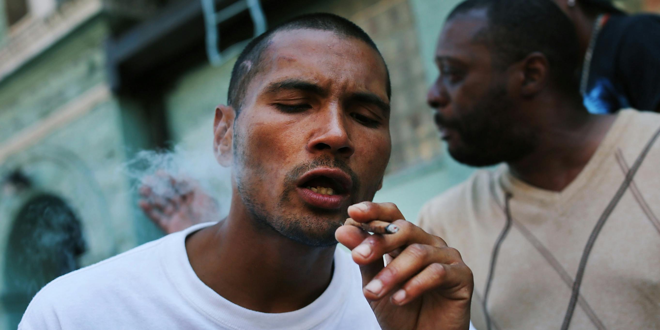 NEW YORK, NY - AUGUST 05: A man smokes K2 or "Spice", a synthetic weed drug, along a street in East Harlem on August 5, 2015 in New York City. New York, along with other cities, is experiencing a deadly epidemic of synthetic marijuana usage including varieties known as K2 or "Spice" which can cause extreme reactions in some users. (Photo by Spencer Platt/Getty Images)