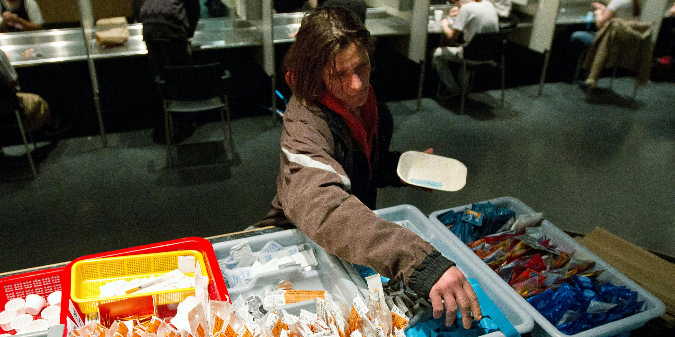 A client of the Insite supervised injection Center in Vancouver, Canada collects her kit on May 3, 2011. Toronto Public Health is currently calling on Canada to decriminalizes all drugs. (Photo by Laurent Vu The/AFP via Getty Images)