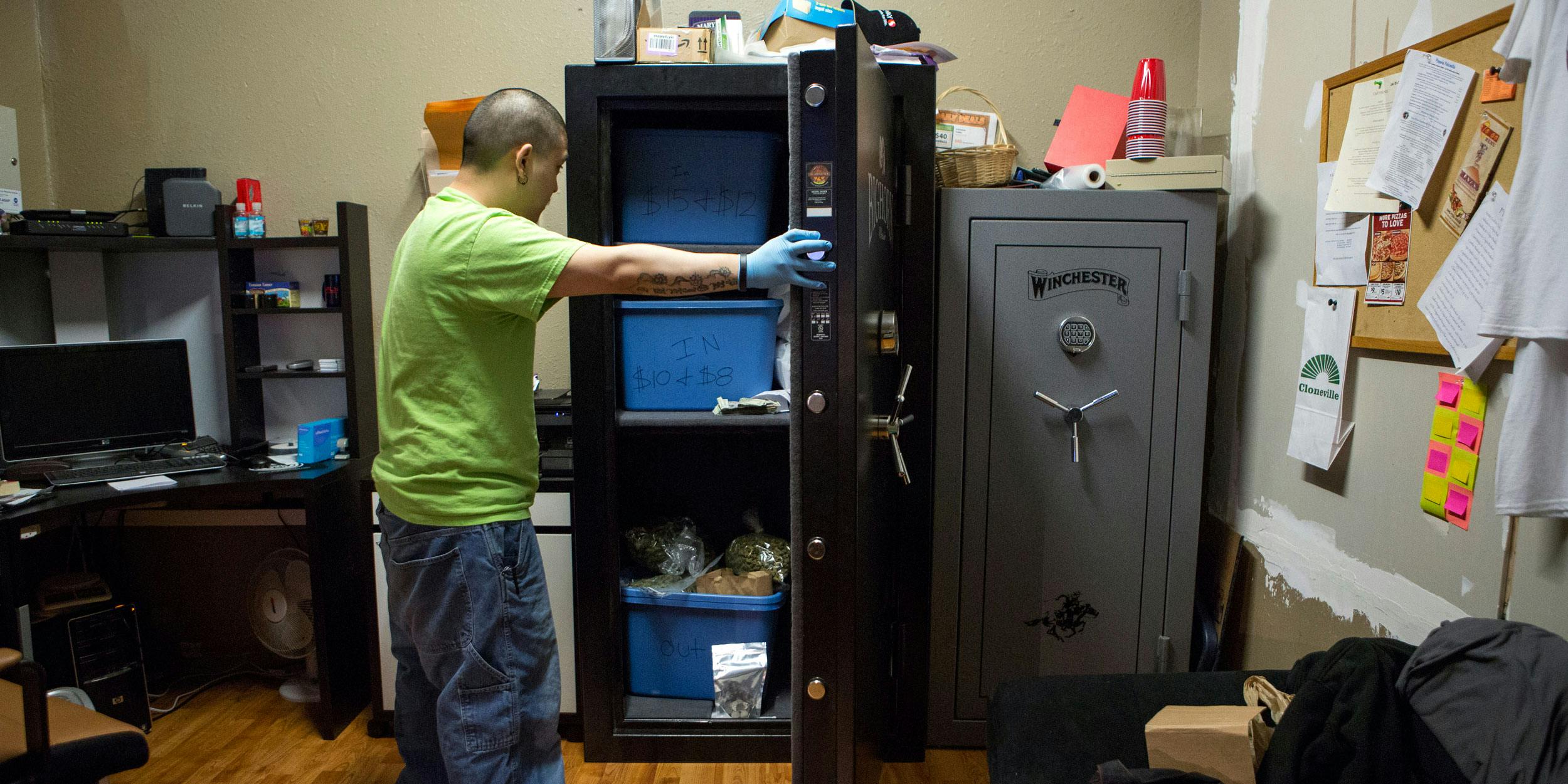 Brendon, the manager of the cannabis store 'A Greener Today,' stores cannabis in safes in the store's backroom on March 14, 2014 in Seattle, Washington. Because federal laws still prohibit the sale of cannabis, stores don't have access to a legal cannabis banking system.
