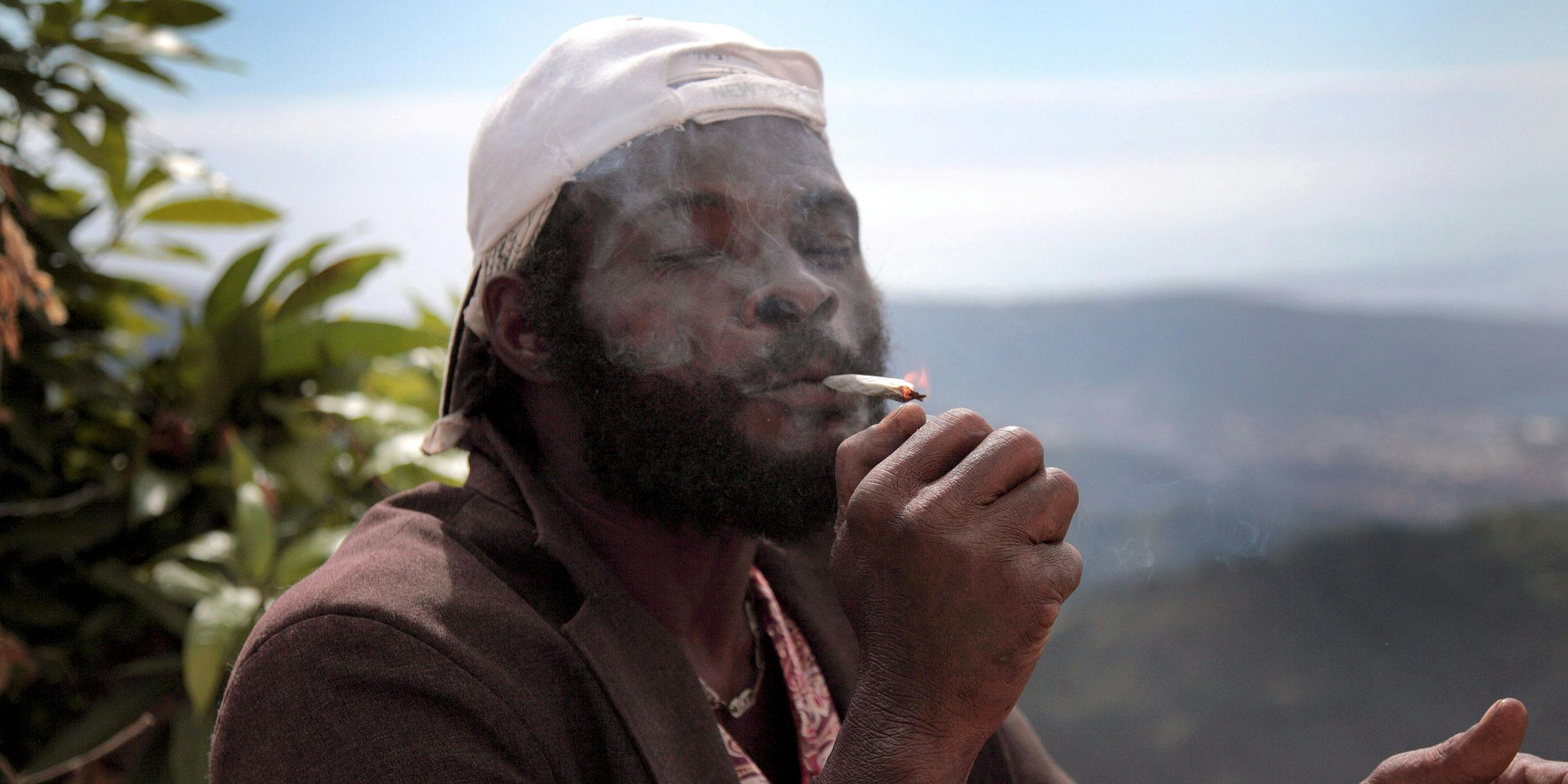 A man in Jamaica smokes weed. Jamaica is one of the five countries most likely to legalize cannabis in the near future.