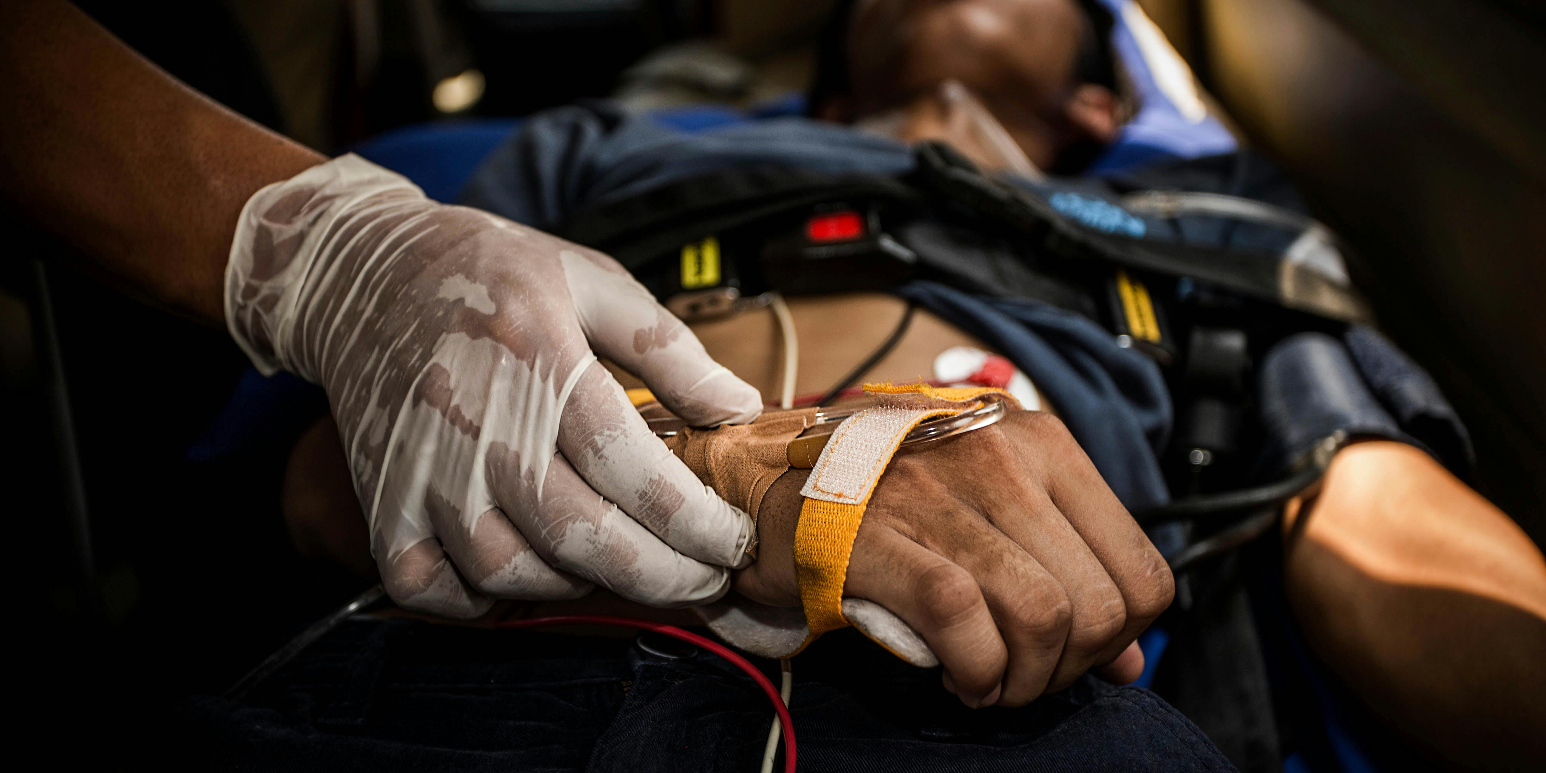 76 Synthetic Marijuana Overdoses Reported on One Day in a Connecticut Park. Here, a man is shown being assisted by paramedics