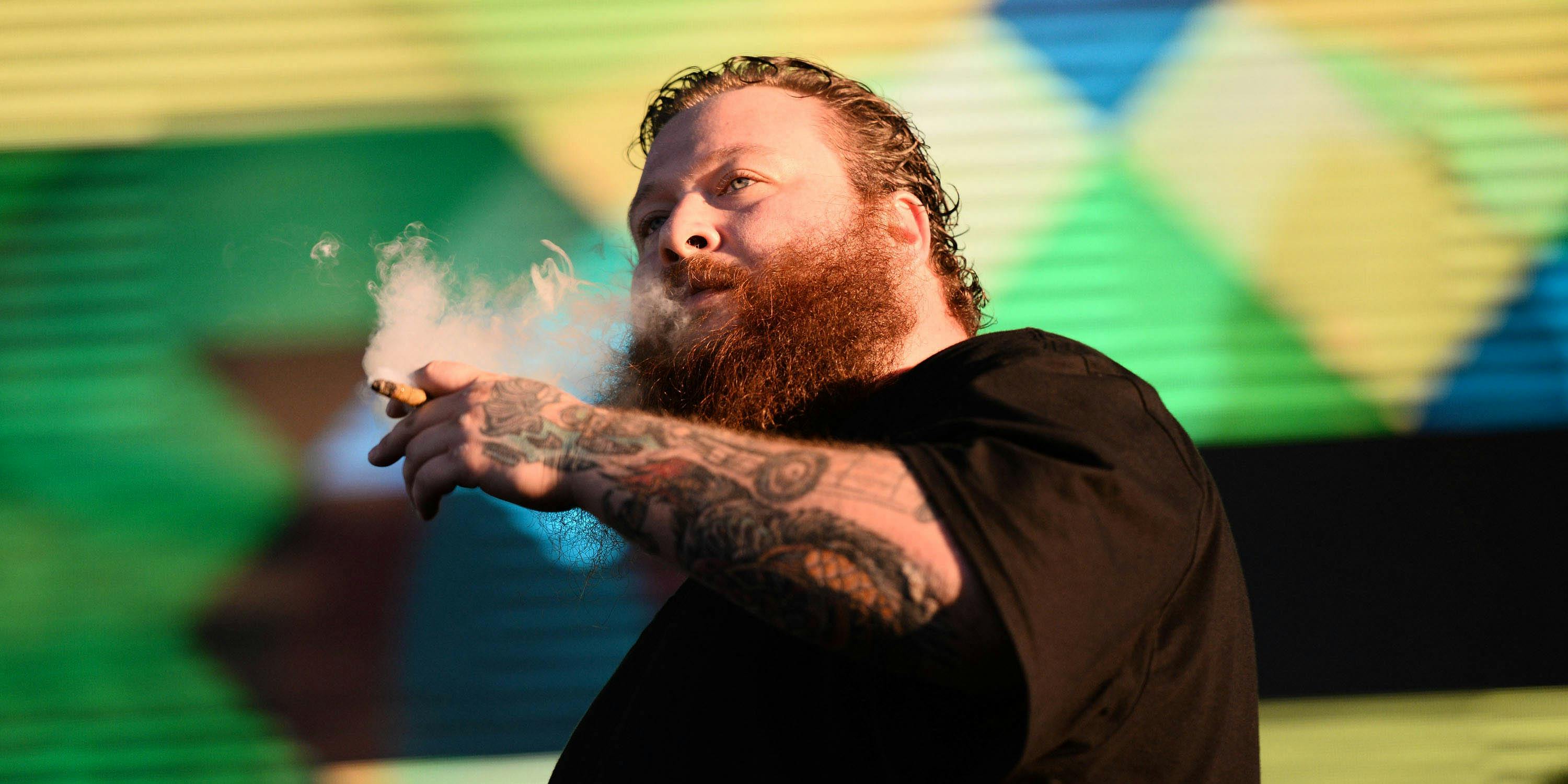 LOS ANGELES, CA - NOVEMBER 08: Rapper Action Bronson smokes a blunt onstage at the 3rd Annual Camp Flog Gnaw Carnival at the Los Angeles Coliseum on November 8, 2014 in Los Angeles, California. (Photo by Scott Dudelson via Getty Images)