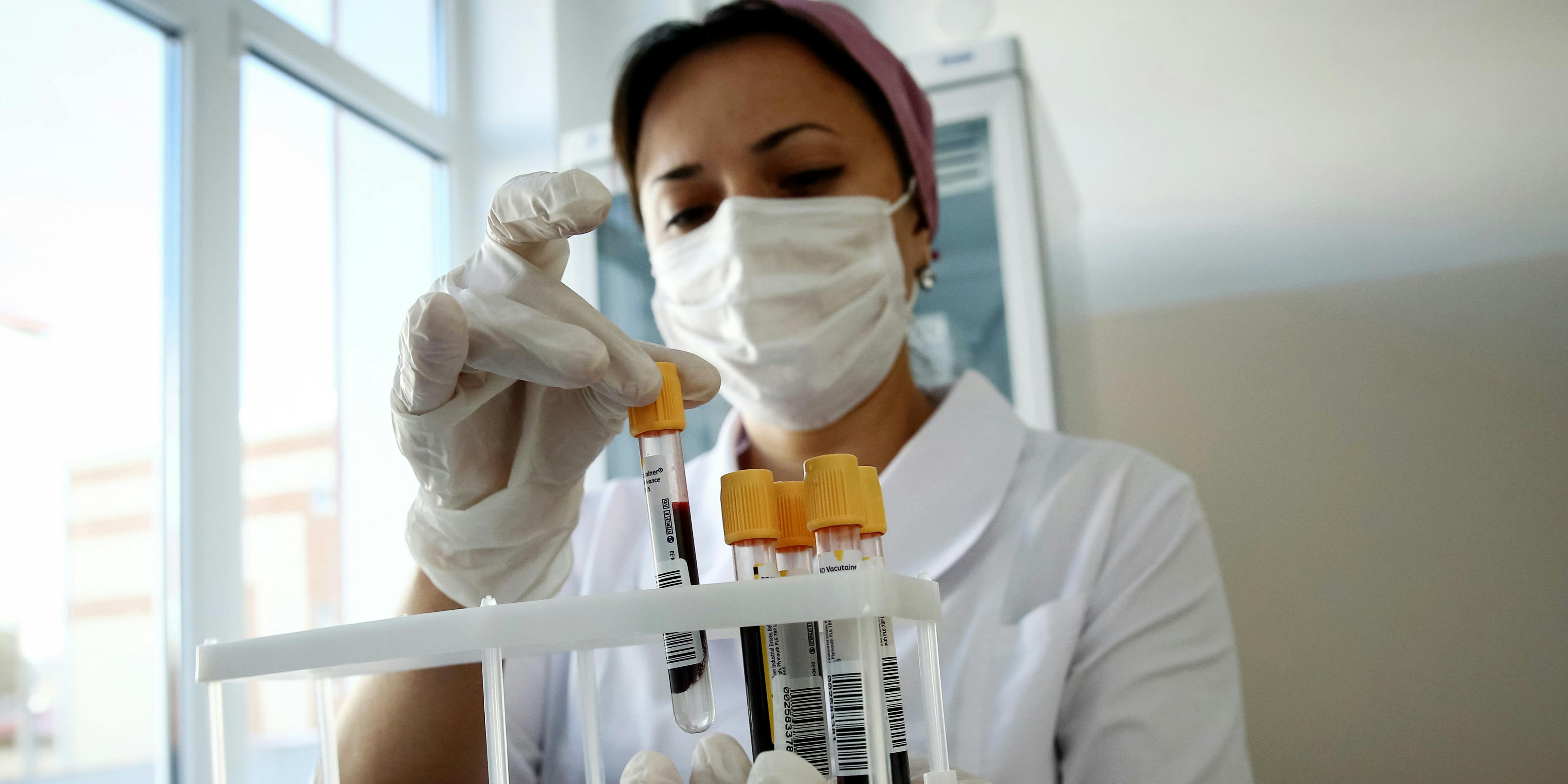 A nurse holds blood samples in a laboratory. A court in New Jersey has ruled that employees can be drug tested because they’re marijuana patients.