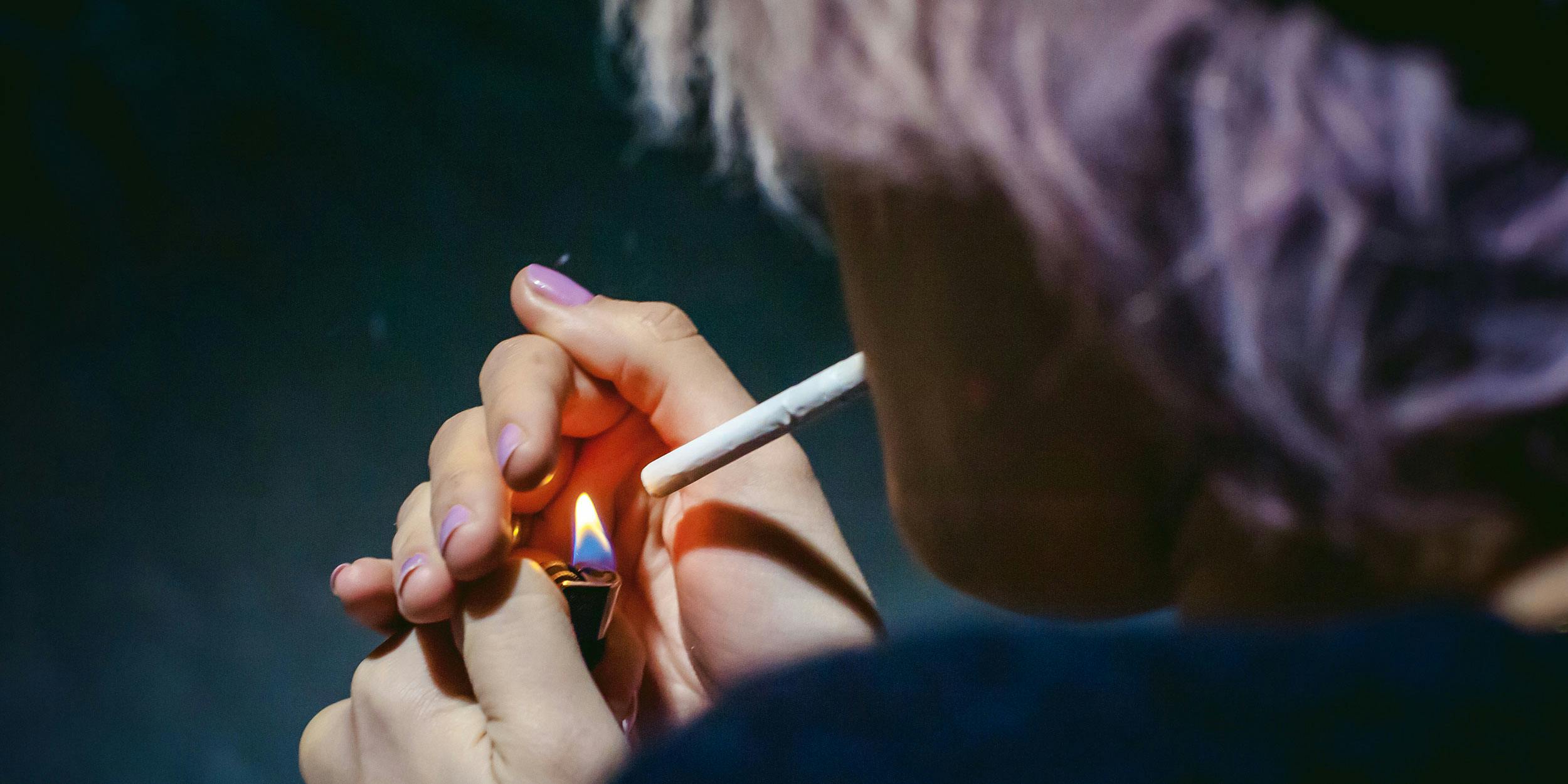 Woman is shown smoking. In the past two years, the number of medical marijuana patients in Oregon has fallen dramatically.