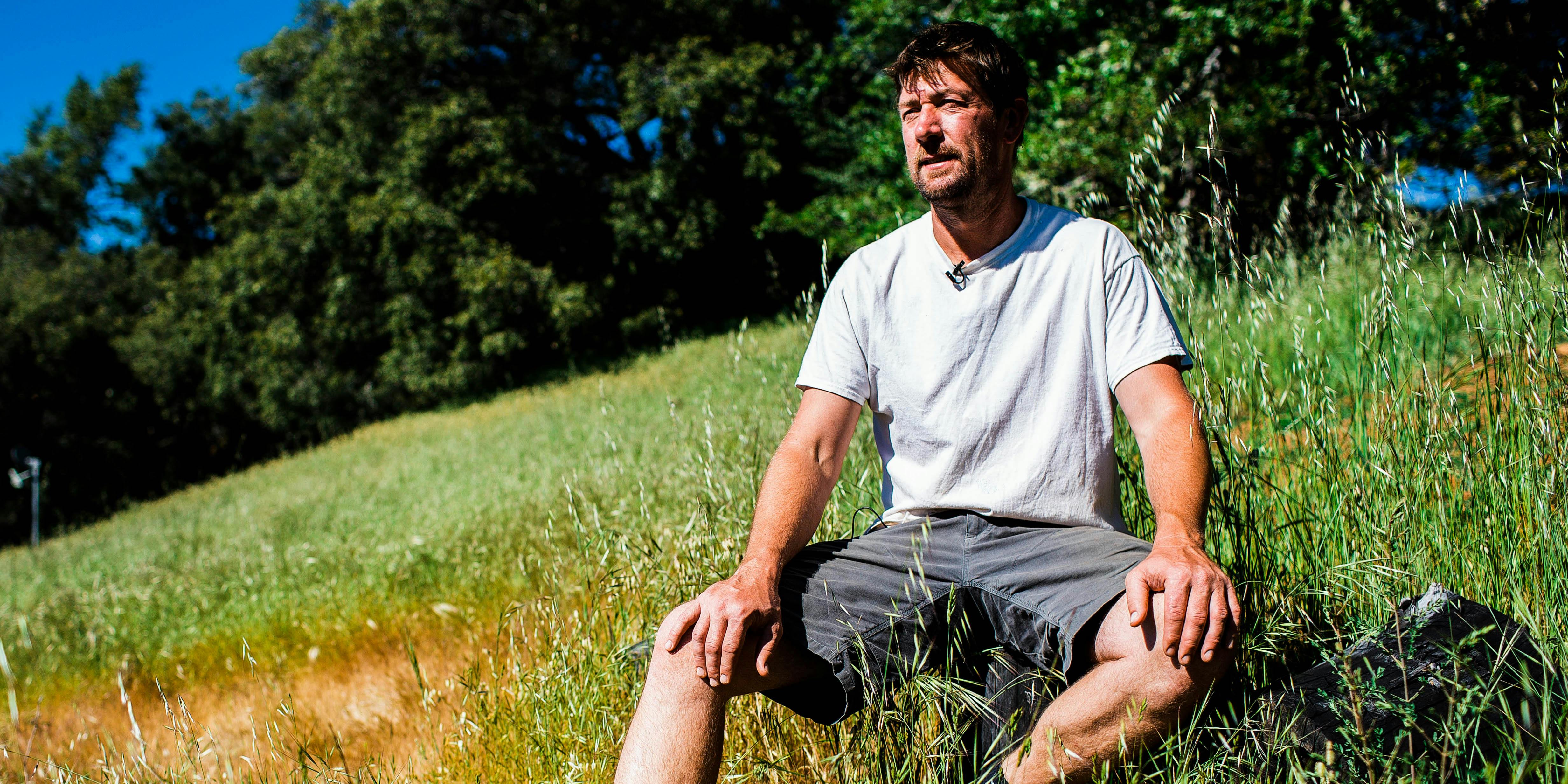 Rio Anderson looks out over a valley from his mountain-top farm in Humboldt County, CA on May 12, 2018.