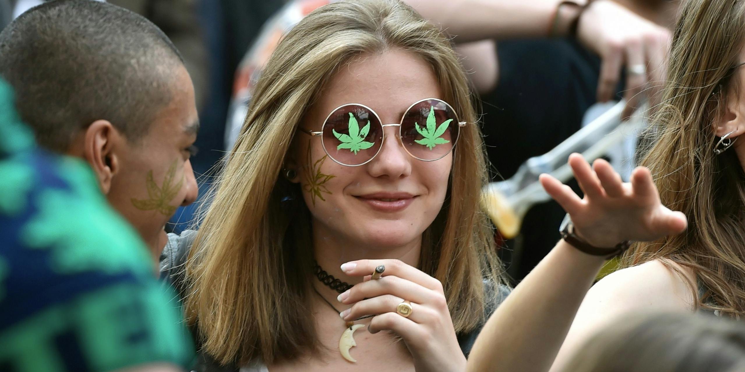 A young woman smokes in Paris on April 29, 2017, during the 16th annual Marche Mondiale du Cannabis to call for the legalization of cannabis. A recent survey found millennials smoke weed way more than their parents. (Photo by Alain Jocard/AFP via Getty images)