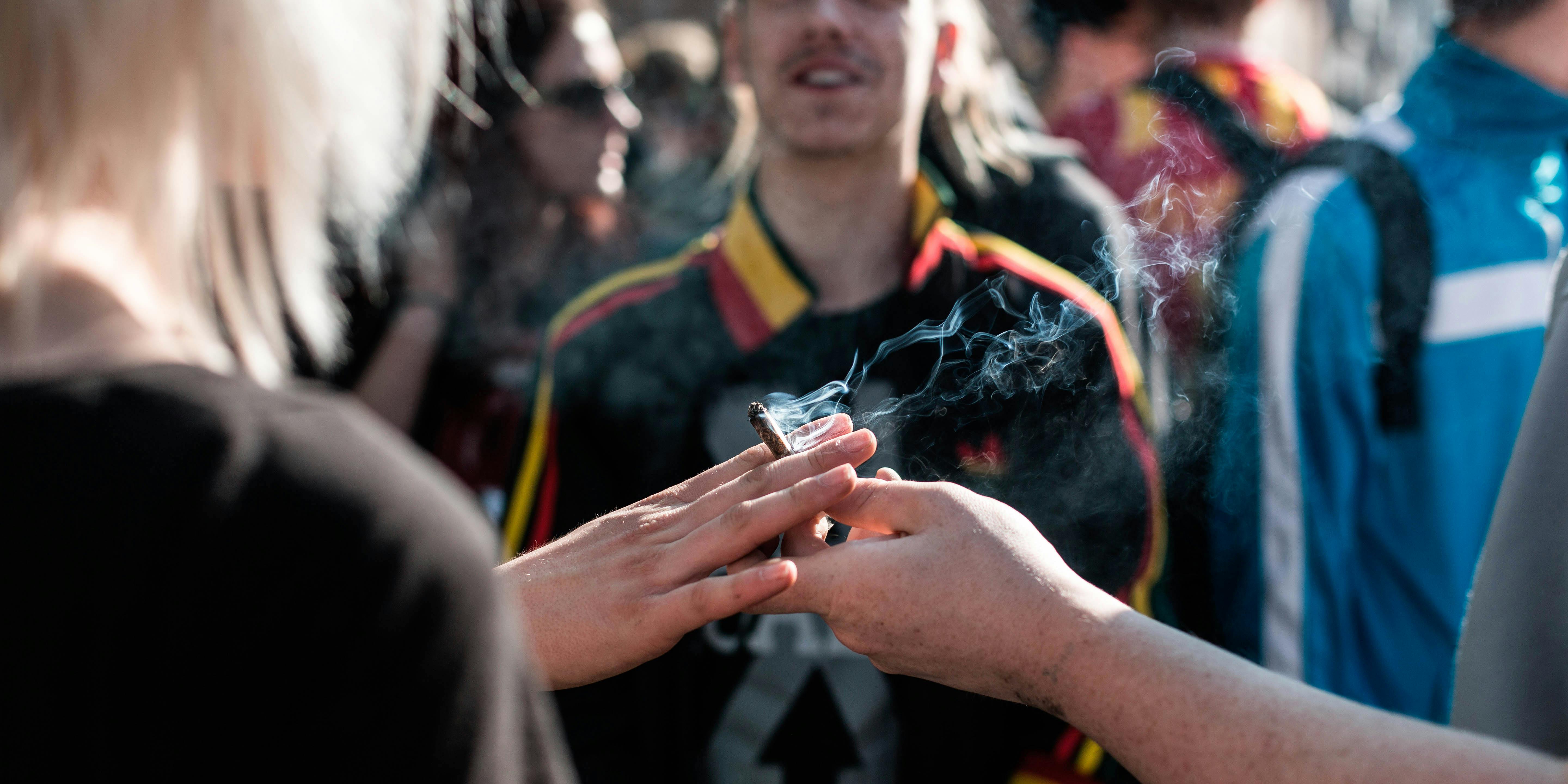 A joint is passed from one hand to another at the annual Pro 420 Cannabis Day in Copenhagen. Denmark 20/04 2014. A recent study found neighborhood dispensaries don't increase adolescent cannabis use