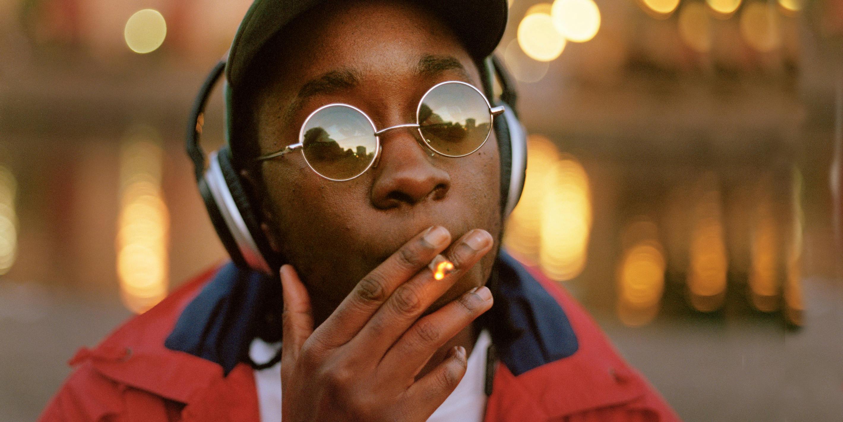 Planet 13 Superstore is Revolutionizing Cannabis Tourism in Las Vegas. Here, a man is shown smoking a joint