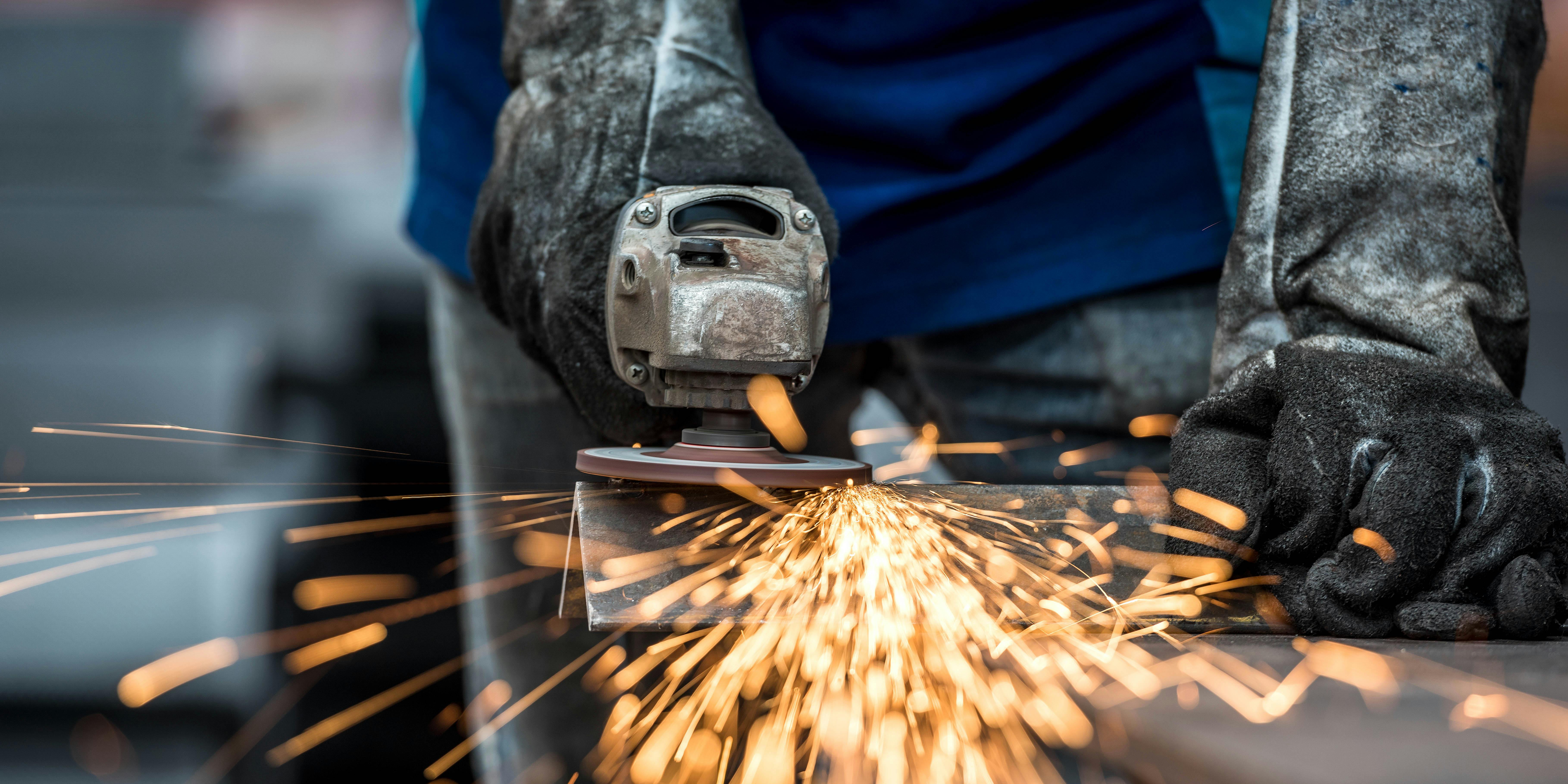 Workplace Deaths Drop in States With Medical Cannabis. Here, an Industrial worker is shown cutting metal with many sharp sparks