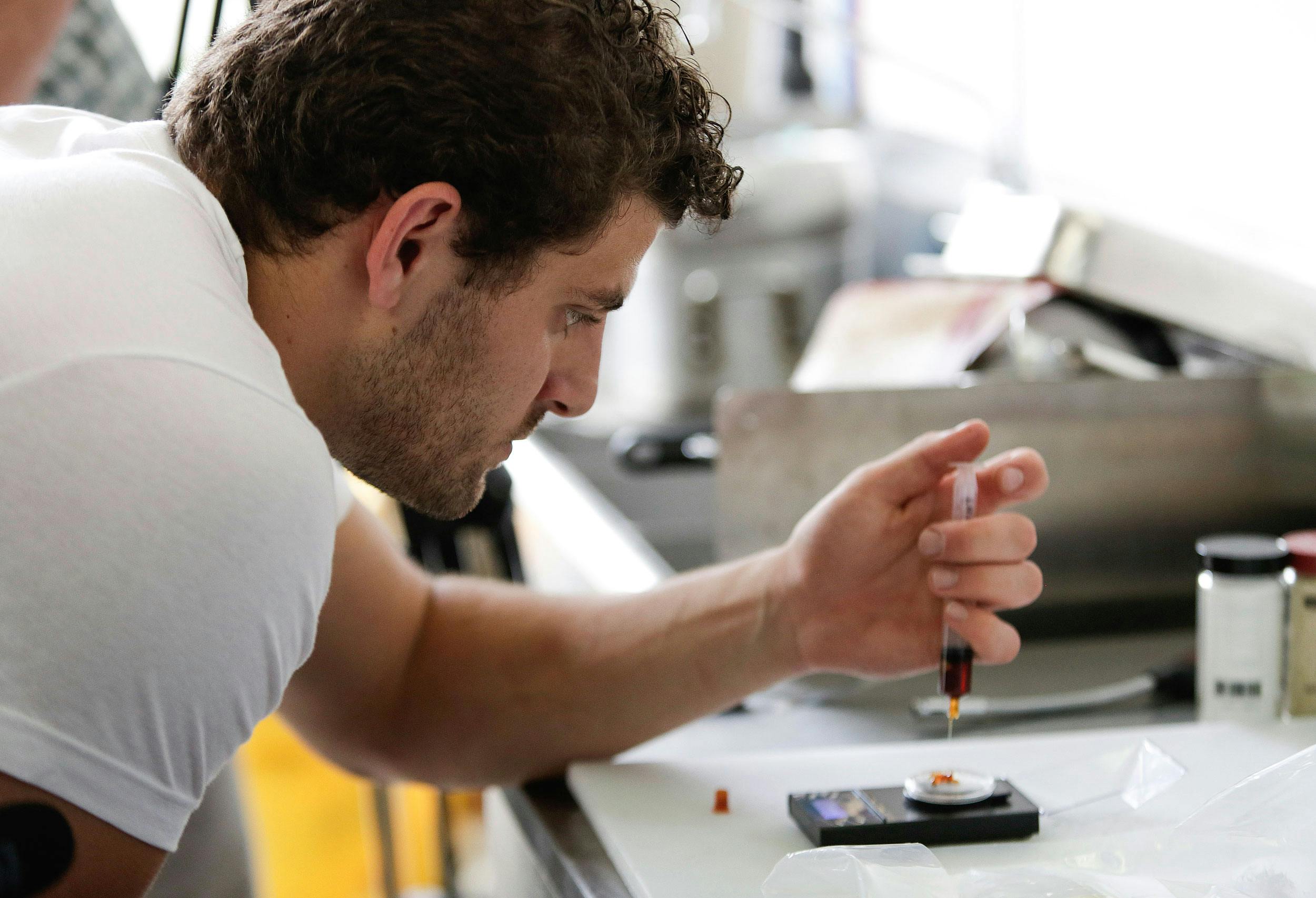 A chef measures the dose of CBD cannabis extract as he prepares medicated food. In this article, Herb explores how Hotels are tapping into the cannabis market by offering CBD Room Service.