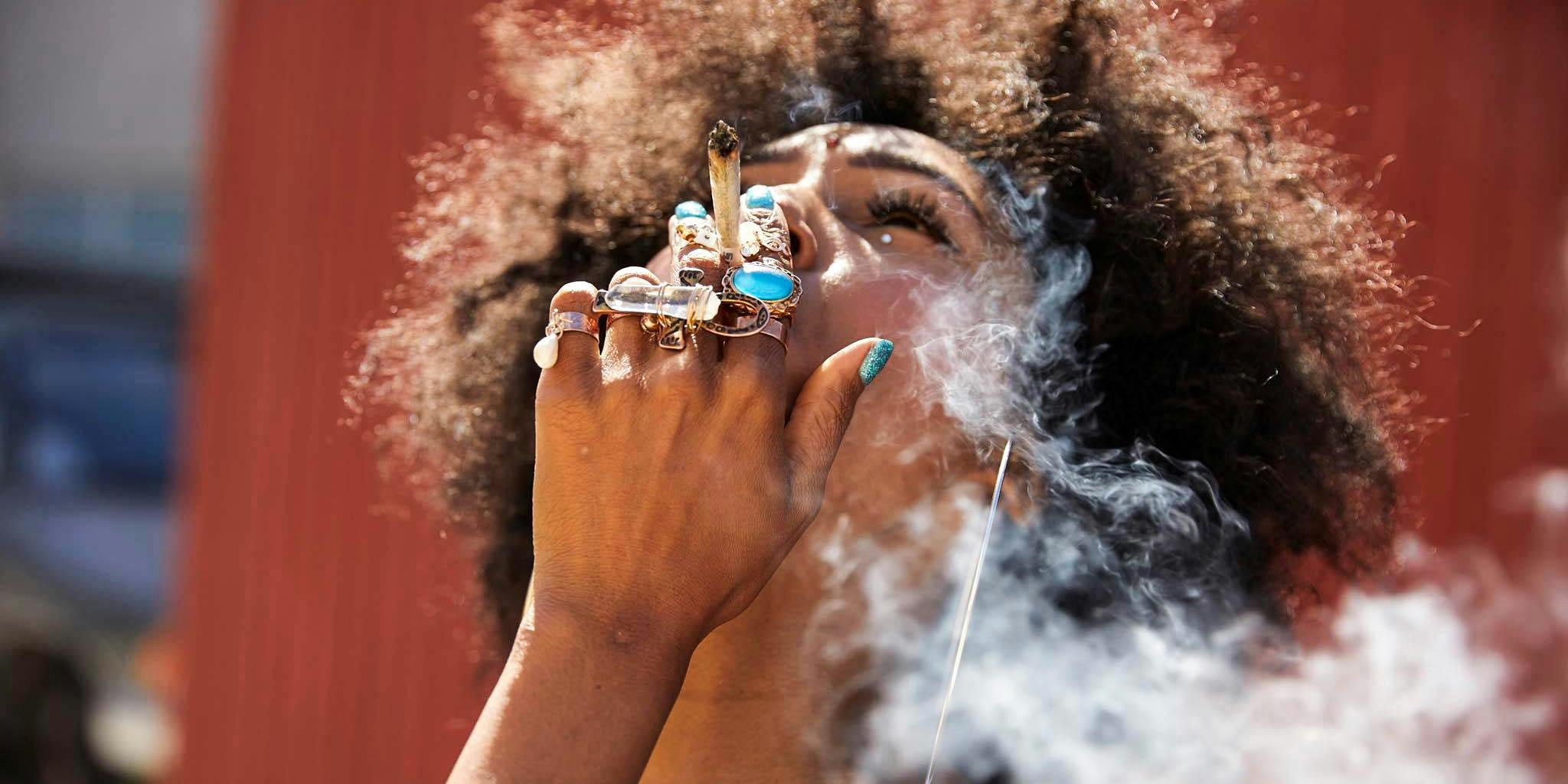 A woman smokes a joint. Many women in cannabis are using social media to spread their message and break stigmas.