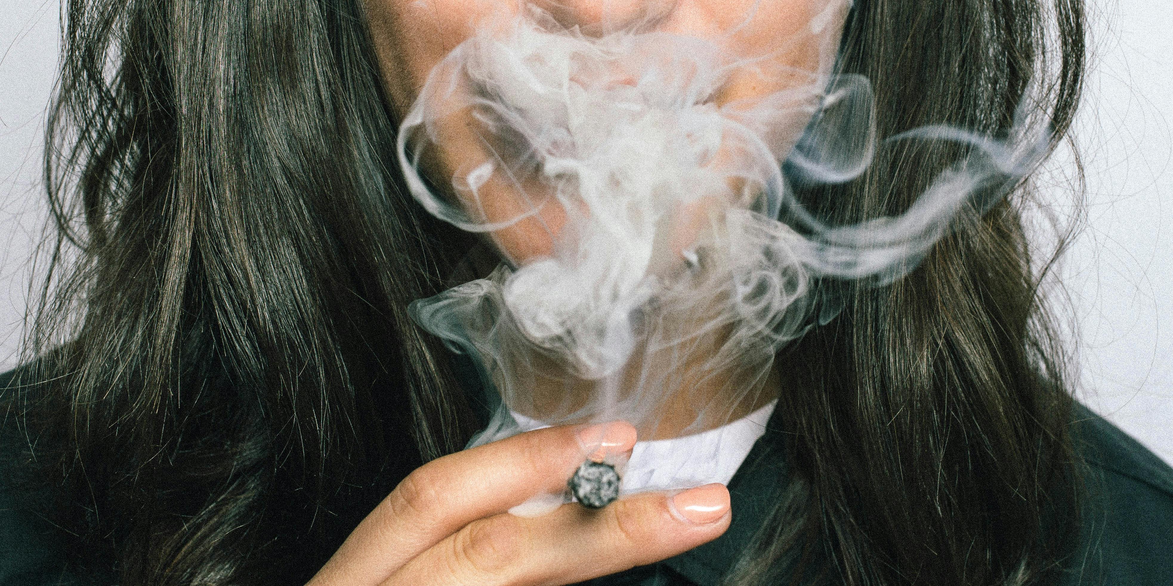 Children Whose Mothers Use Cannabis Try It At A Younger Age. Here, a woman is shown smoking