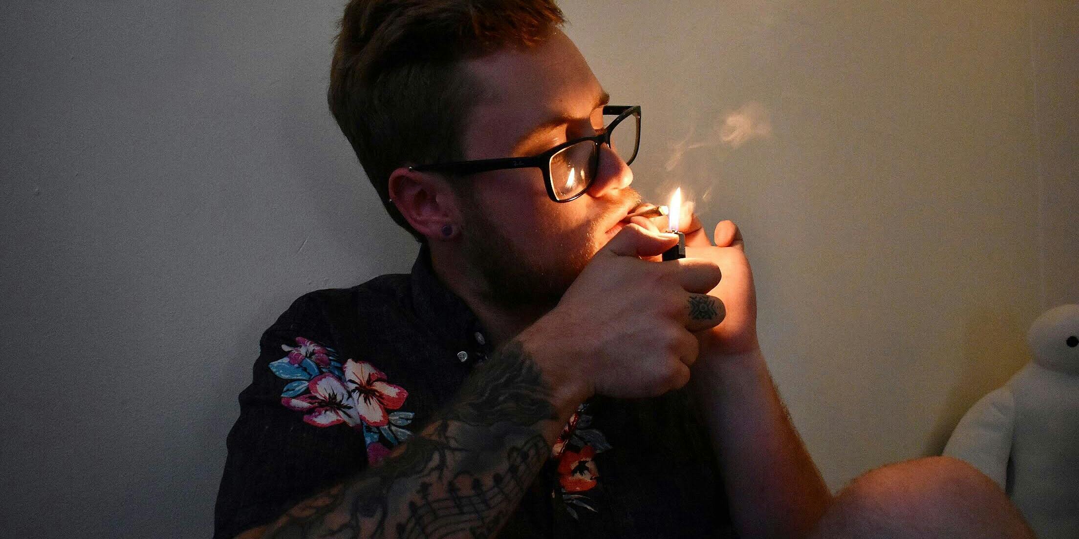 . More 19 to 22-Year-Old Americans Are Consuming Cannabis Than Ever Before. Here, a young man is shown hitting a bowl