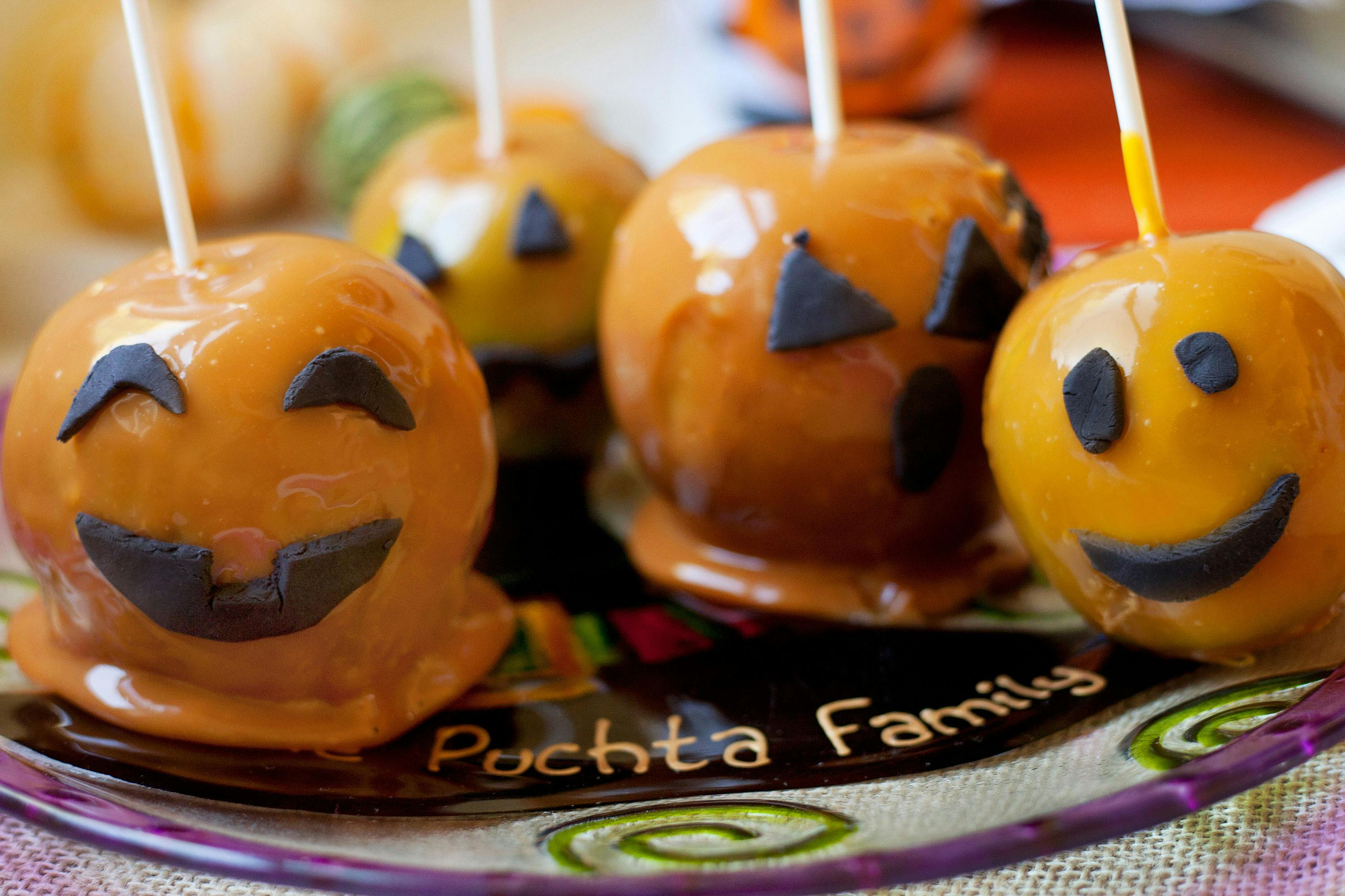 Caramel apples are among the best halloween edibles. Here, apples decorated like jack-o-lanterns are shown
